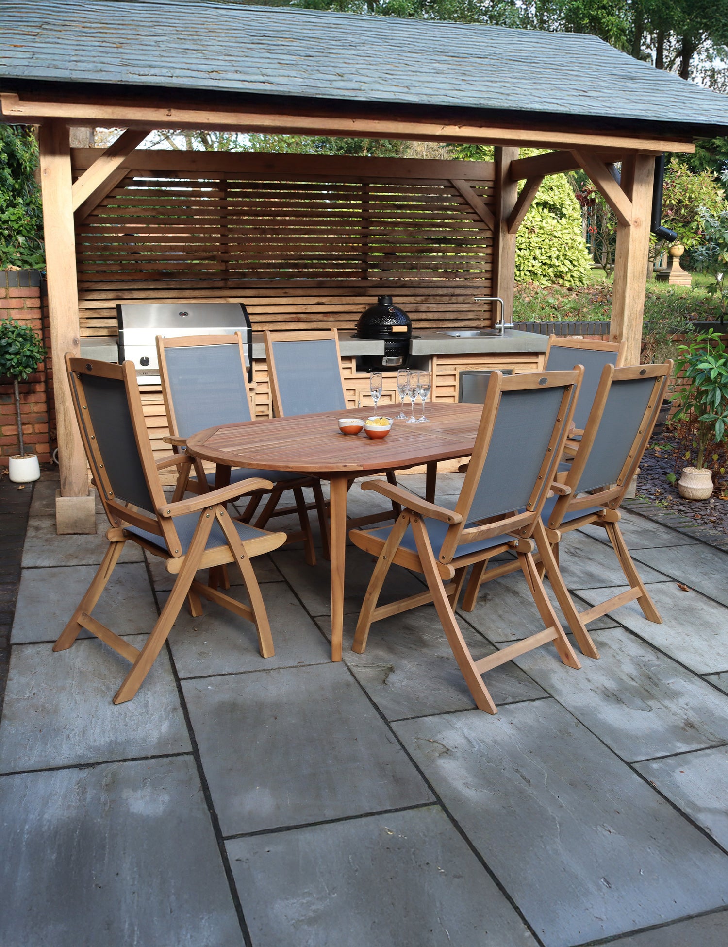 Wooden garden dining set with six chairs under pergola