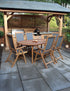 Wooden garden dining set with six chairs under pergola