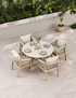 Round garden dining set with four woven chairs