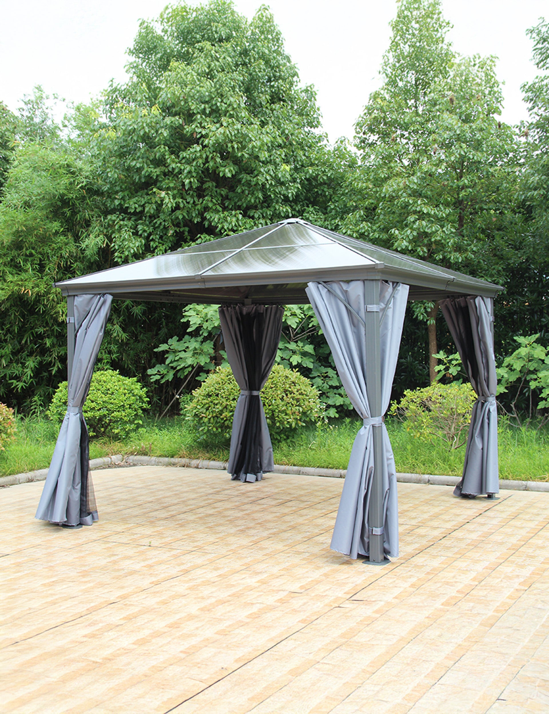 Outdoor gazebo in grey over seating area on stone patio