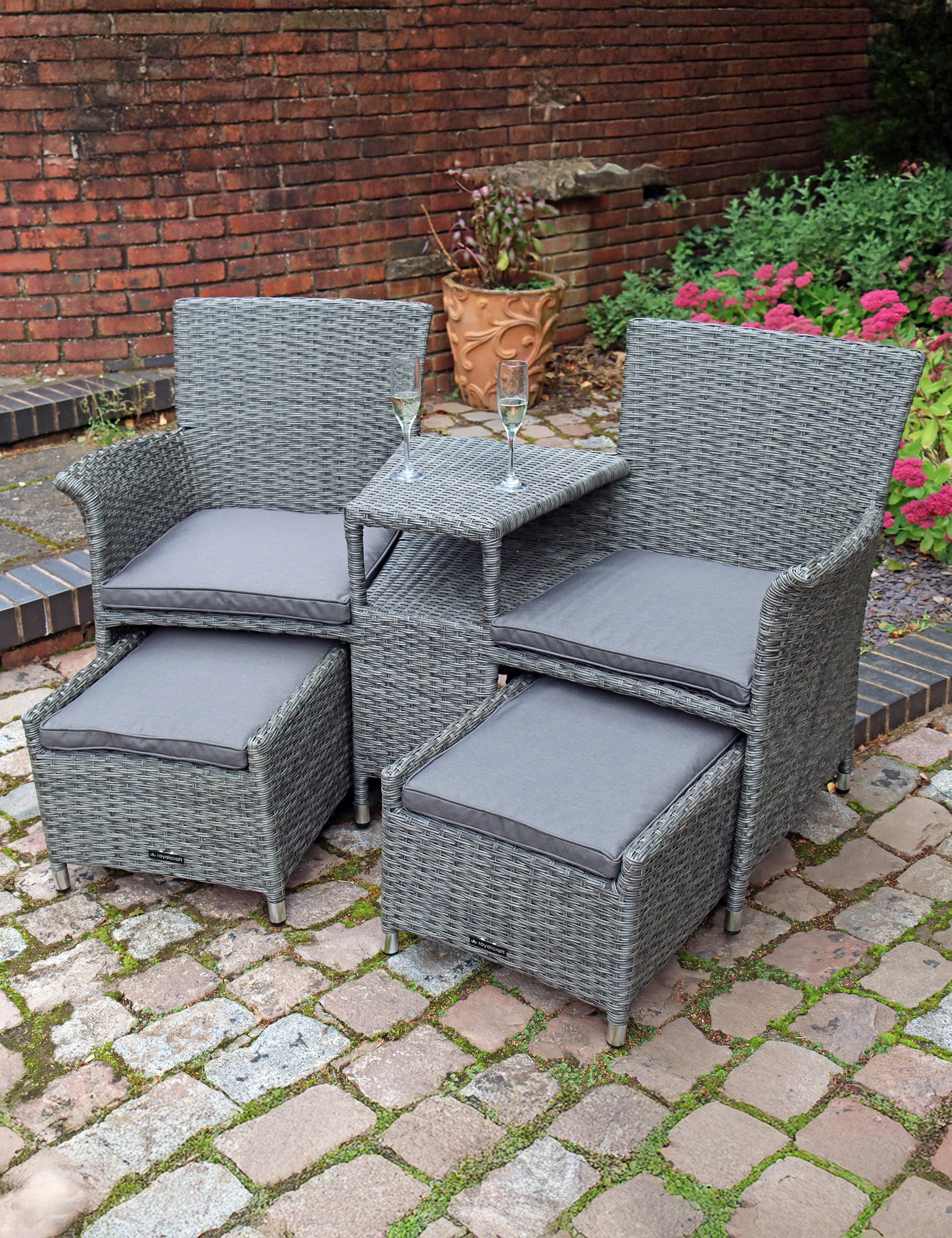 Grey rattan companion set with two cushioned chairs and side table