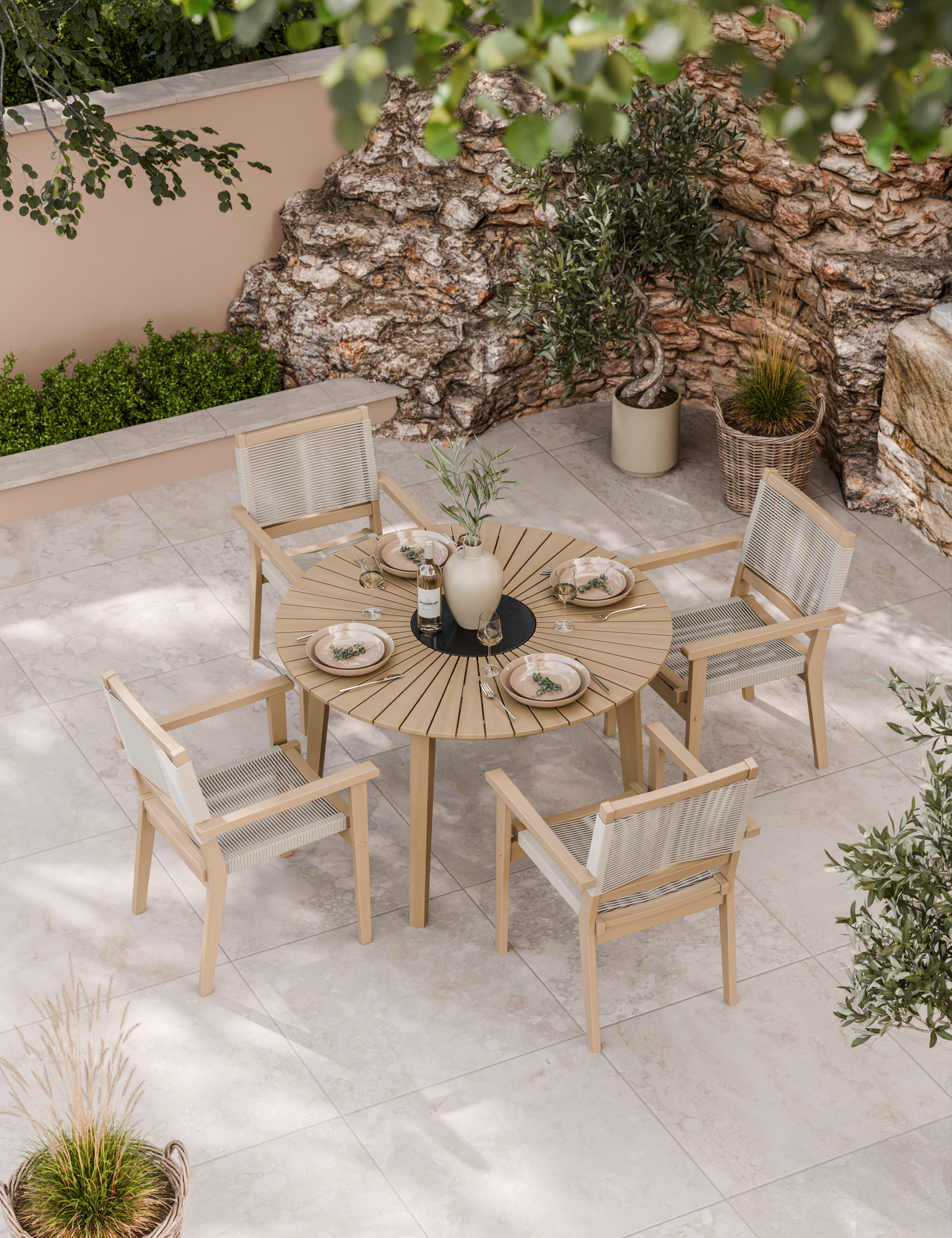 Outdoor patio set with round wooden table and cushioned chairs