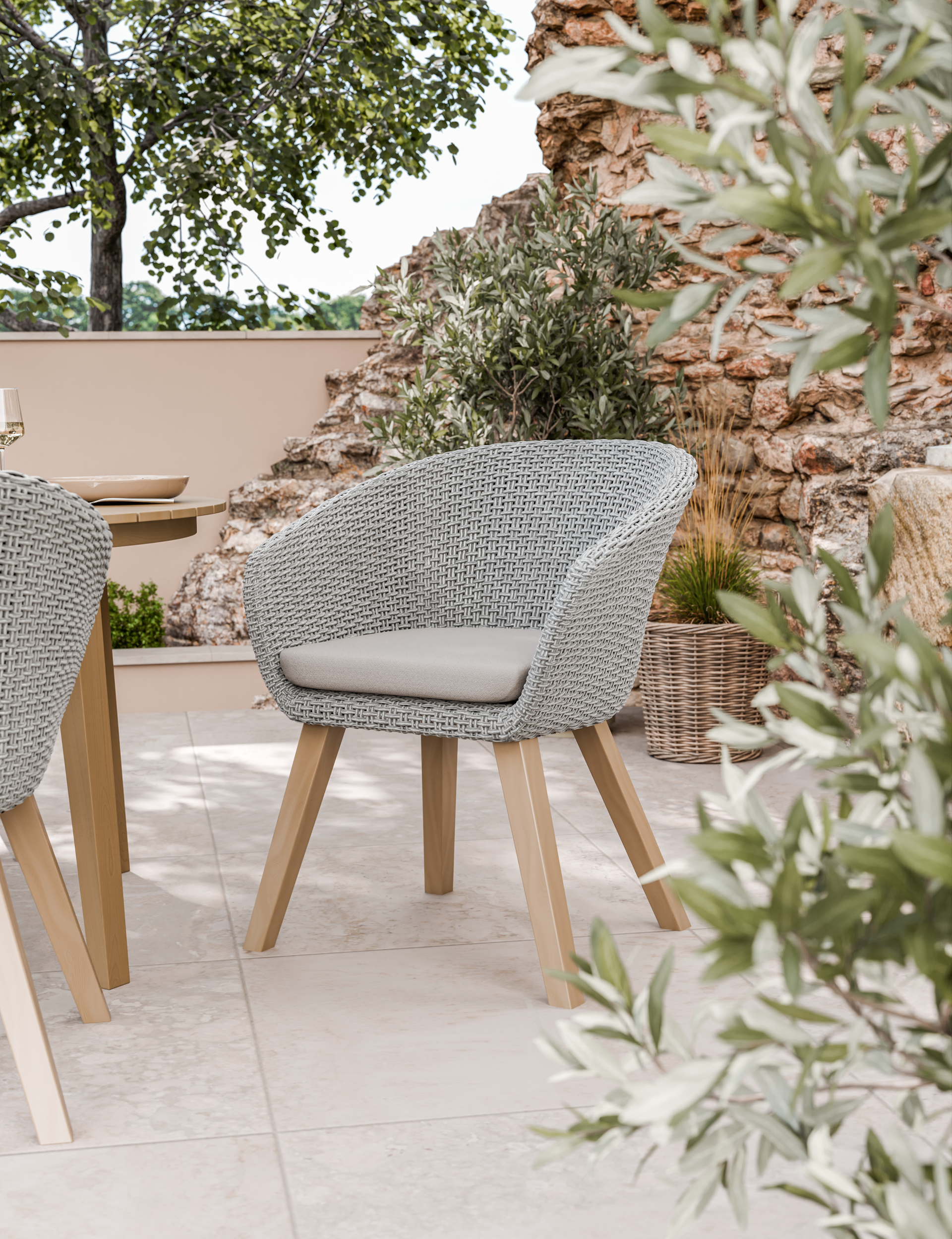 Grey woven outdoor chair with cushion on tiled patio