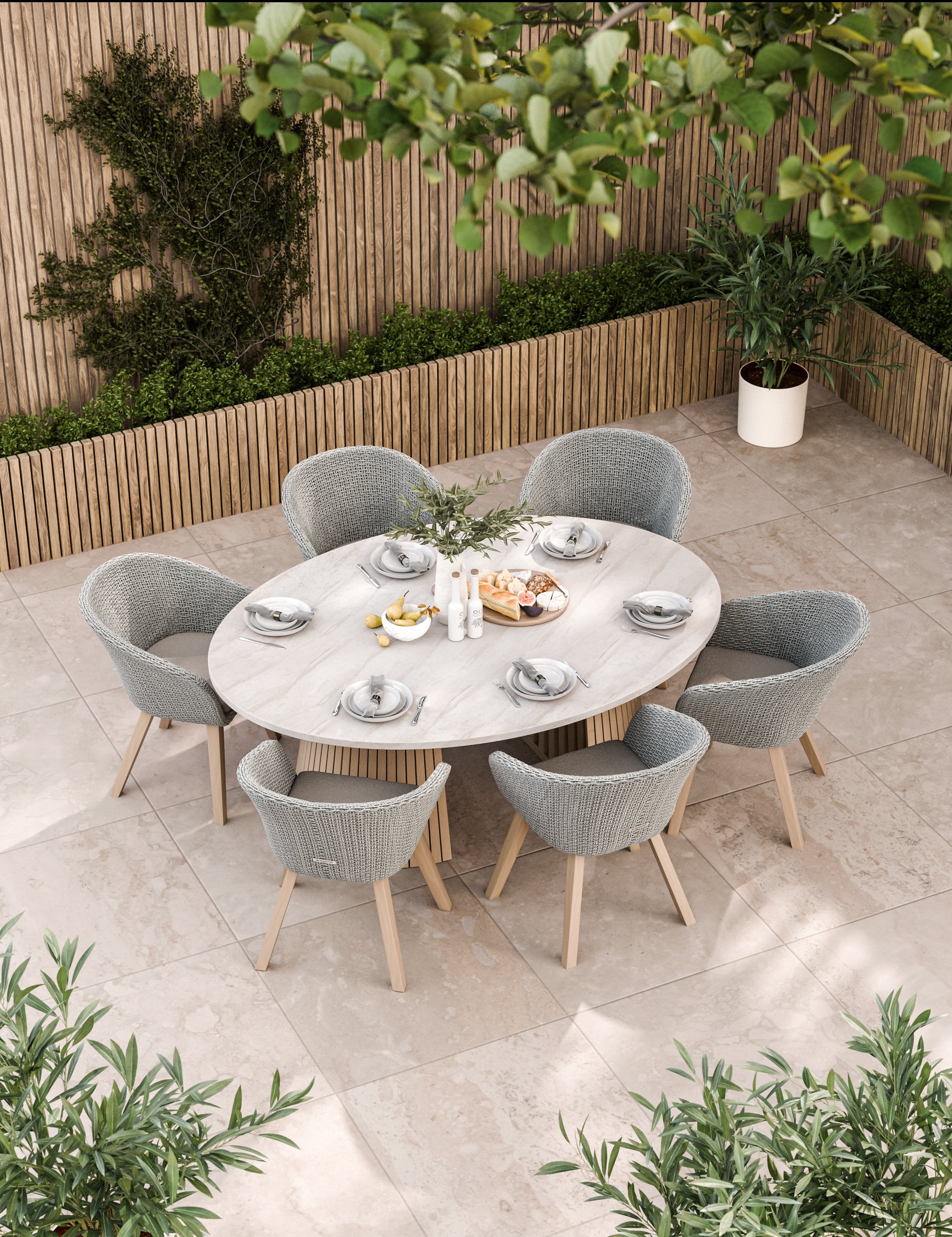Oval outdoor dining table with six cushioned grey chairs
