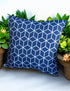 Blue outdoor cushion with white geometric cube pattern