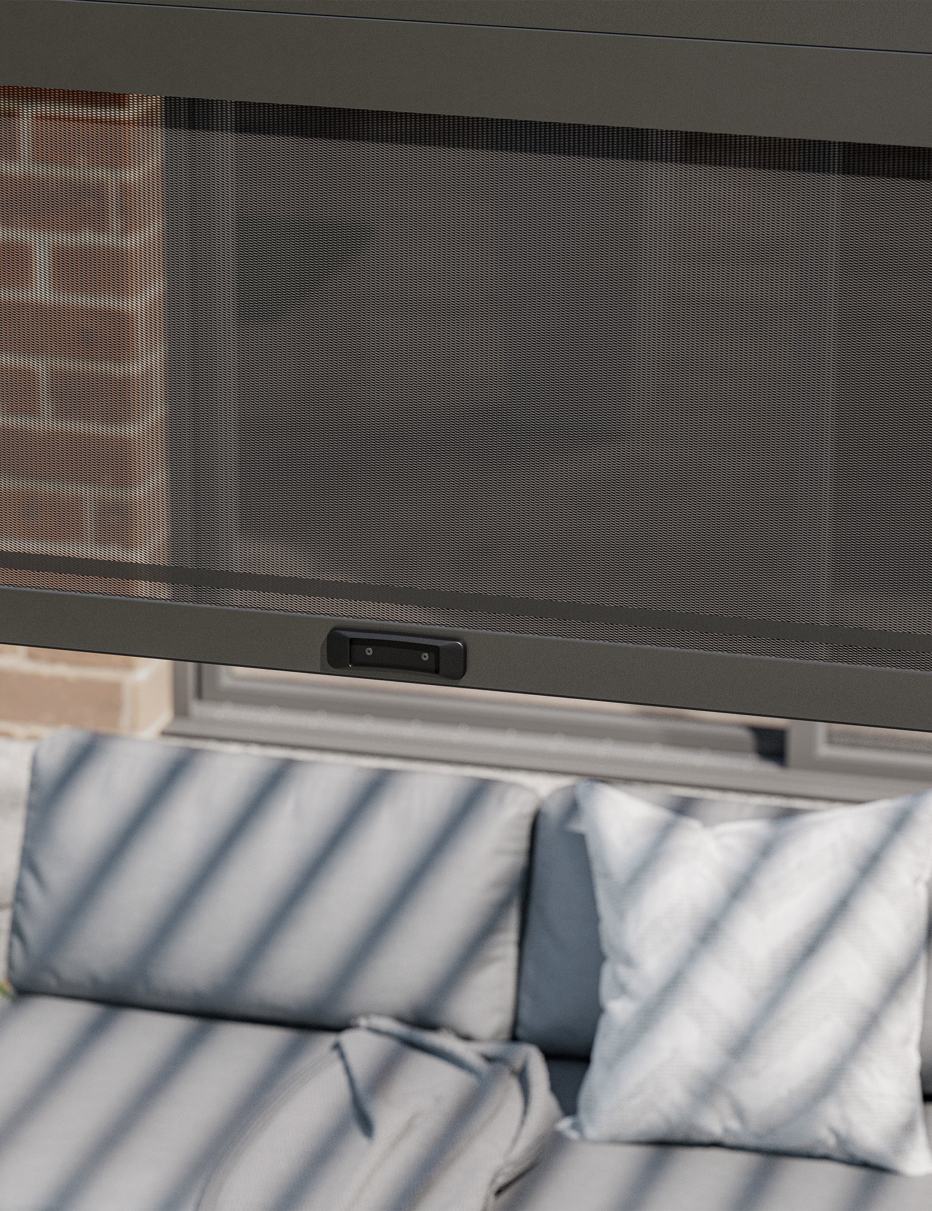 Close-up of pergola side blind with mesh detail above grey cushions