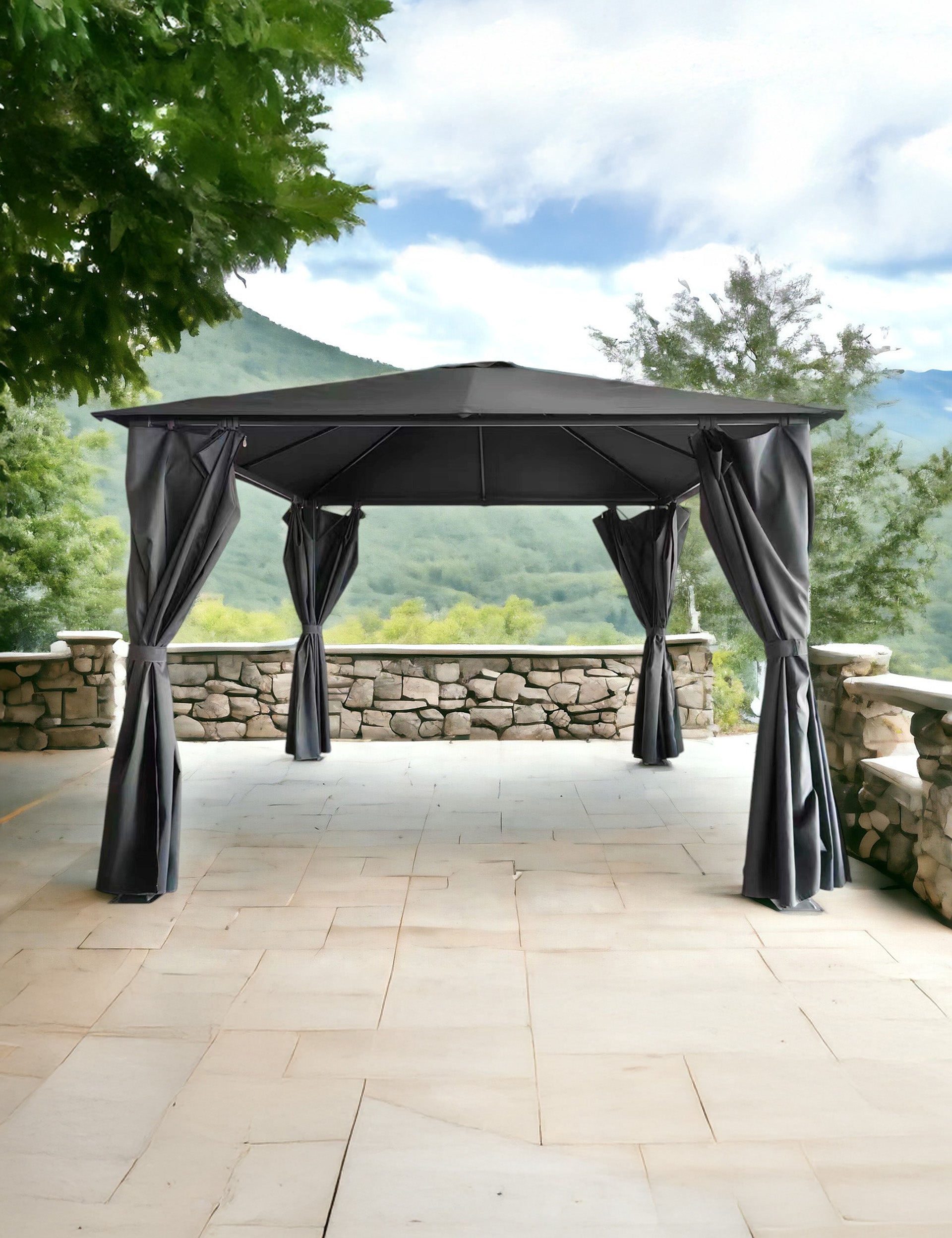 Black outdoor gazebo with curtains on a stone patio overlooking hills