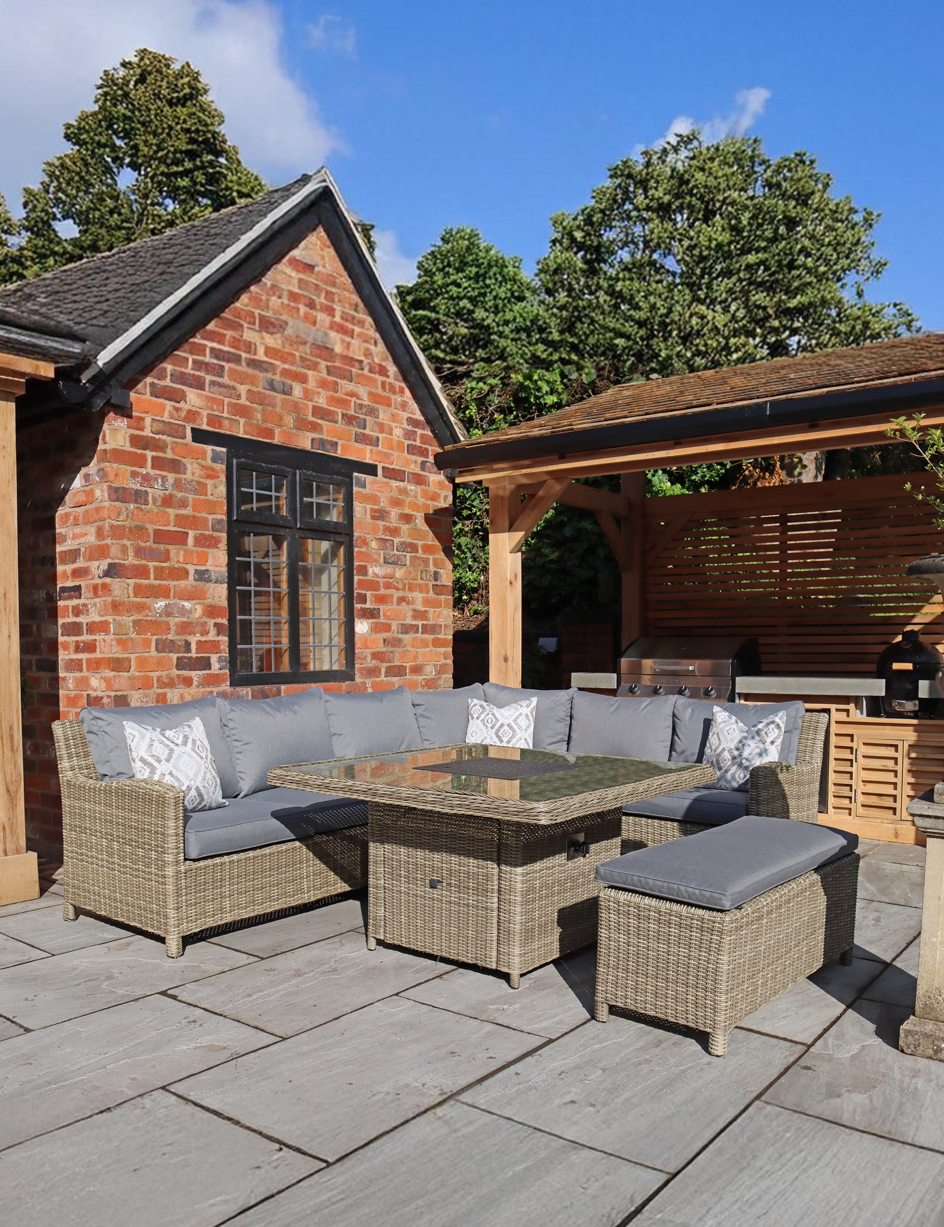 Rattan corner dining set with grey cushions and glass-top table