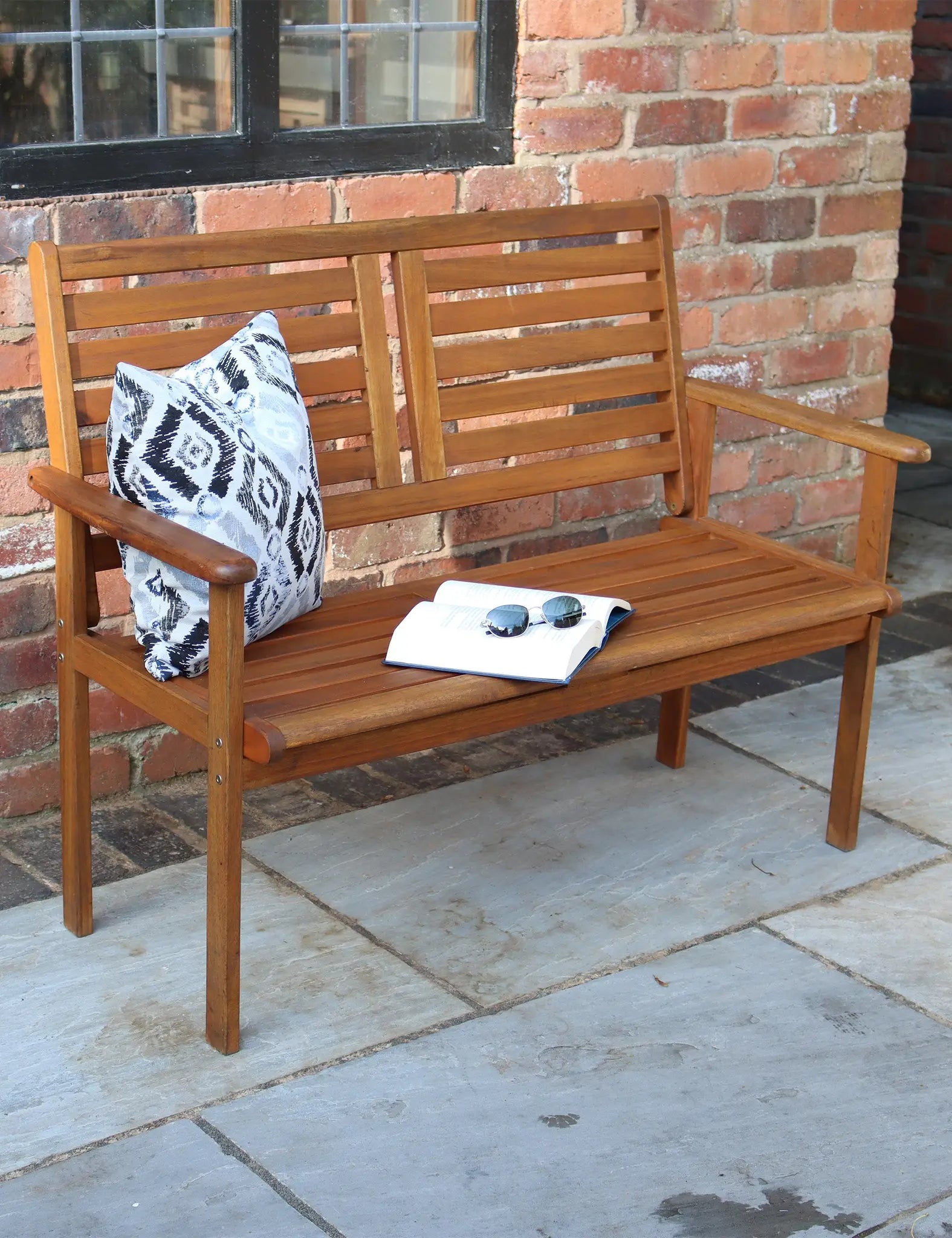 Wooden patio bench with cushion