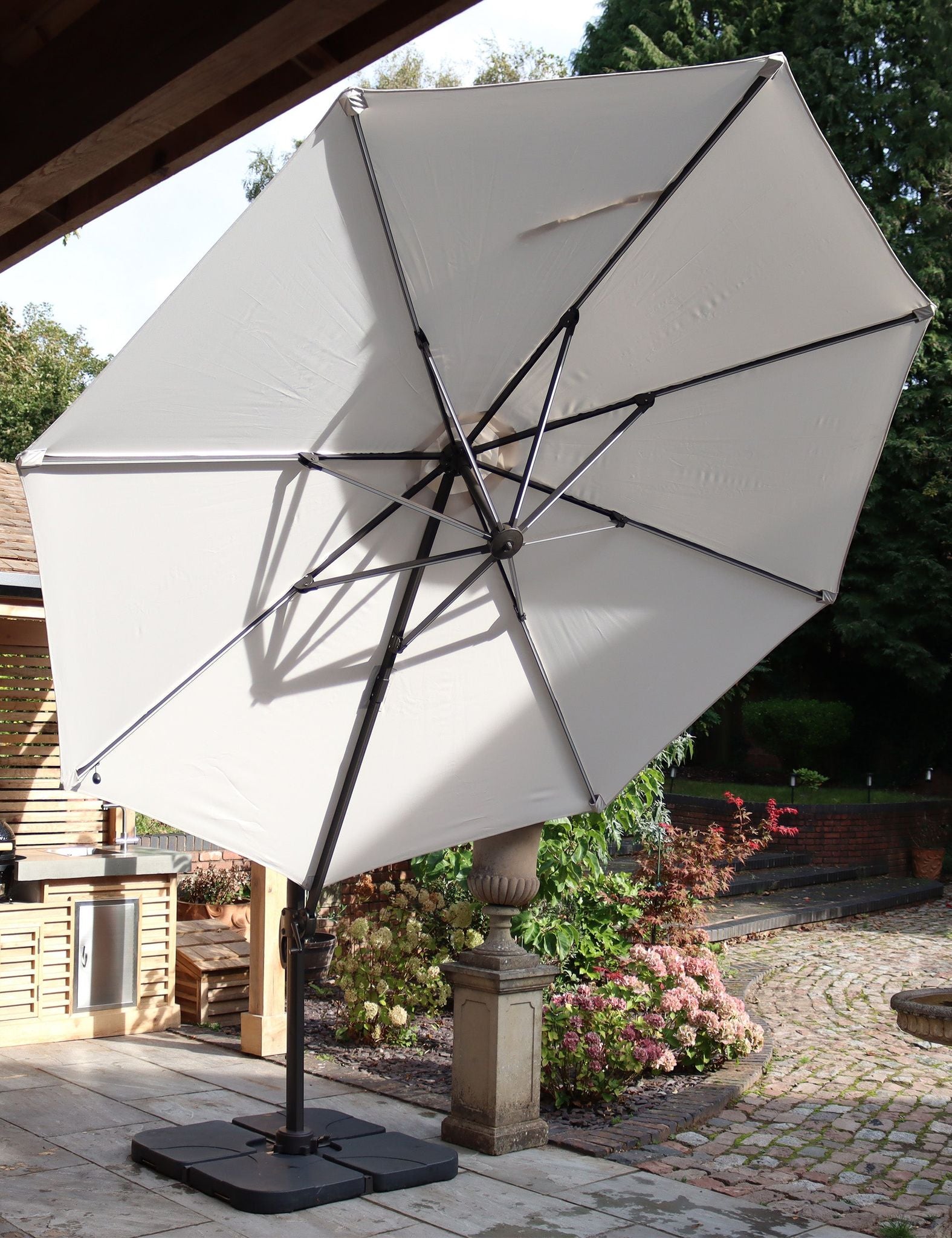 Image of Charcoal crank-tilt round parasol canopy with central hub and eight supporting ribs