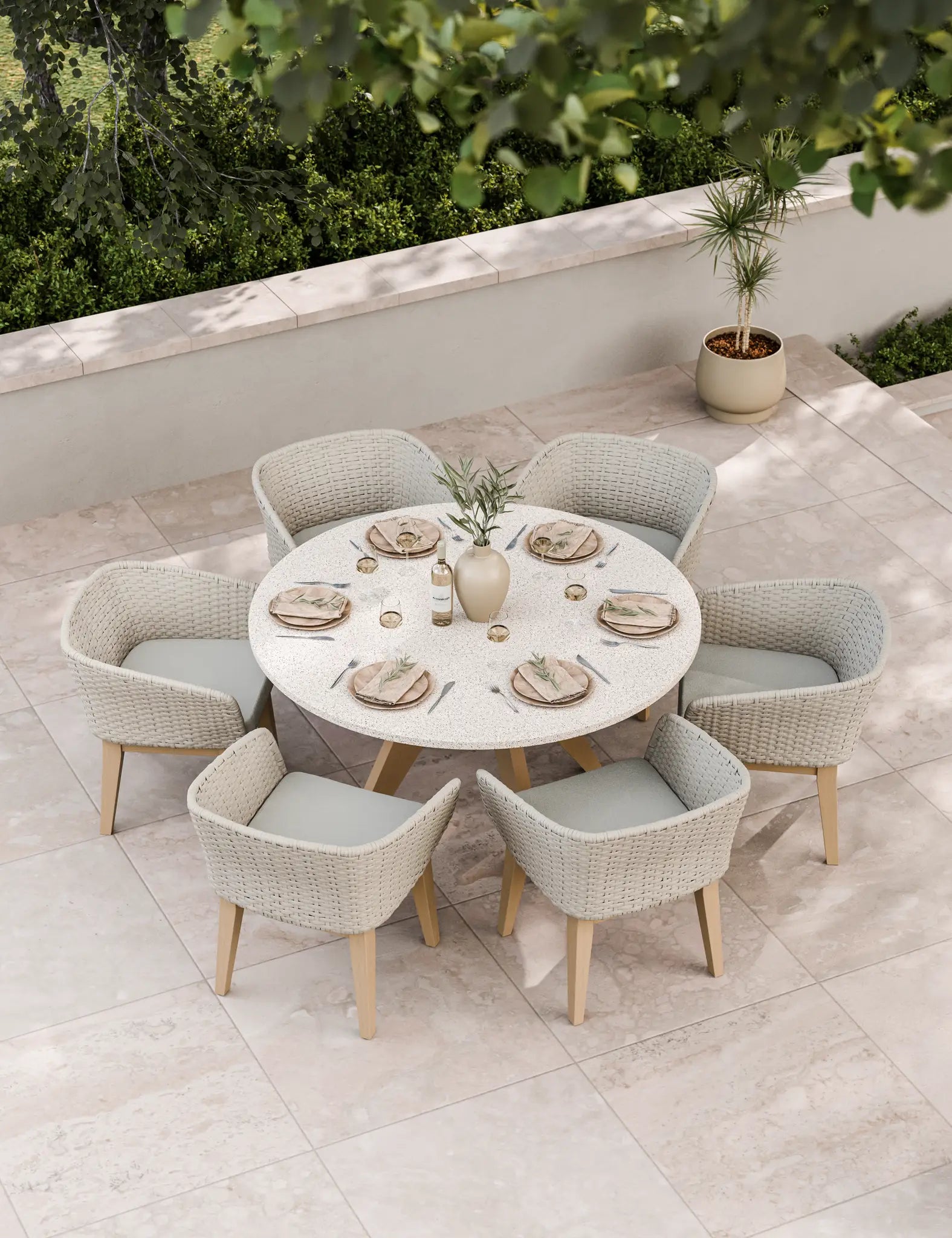 Six-seater patio dining set in neutral tones on stone paving