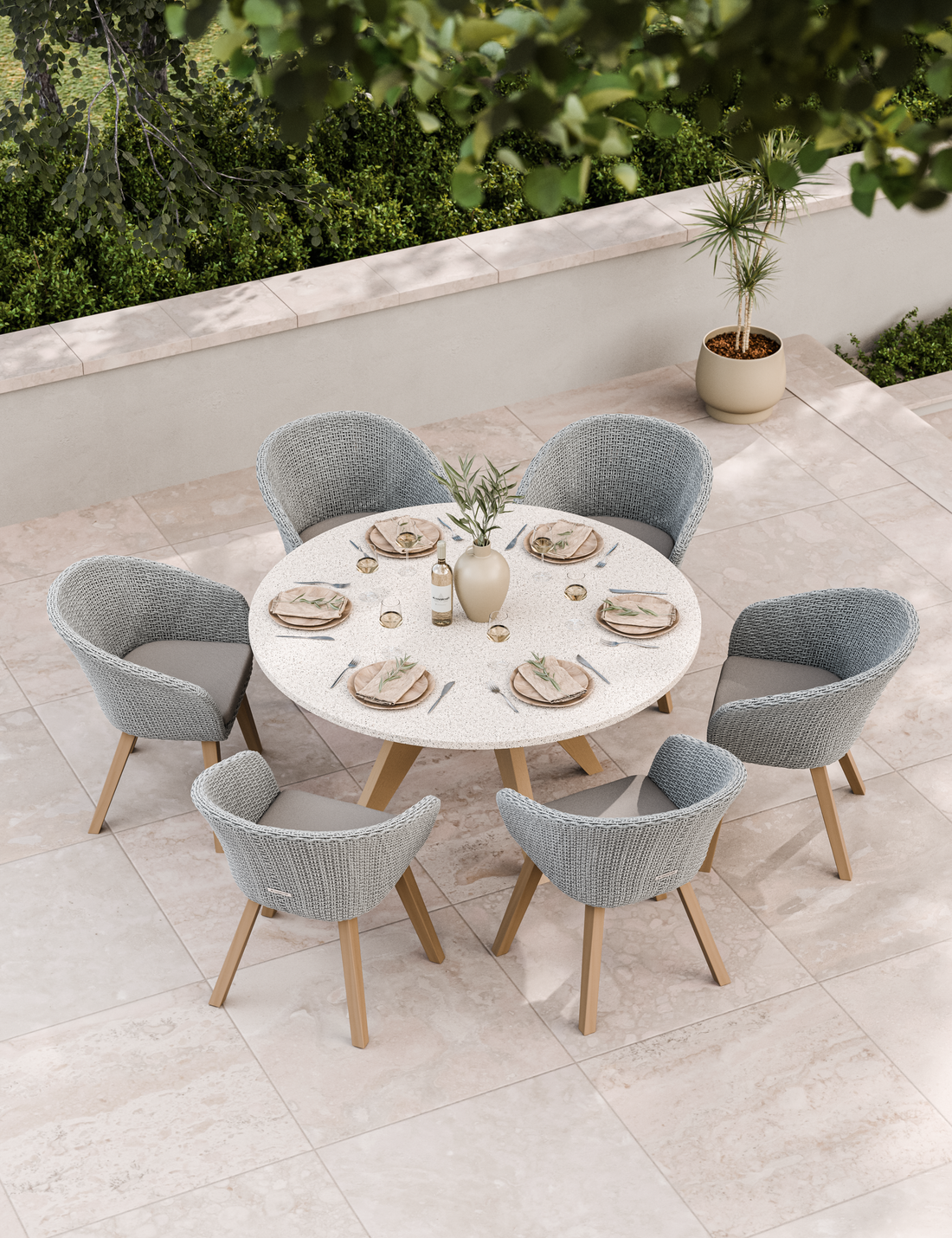 Six-seater patio dining set in neutral tones on stone paving