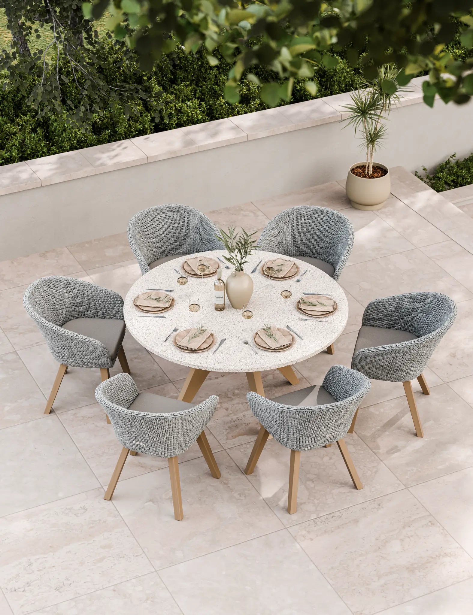 Image of Six-seater patio dining set in neutral tones on stone paving