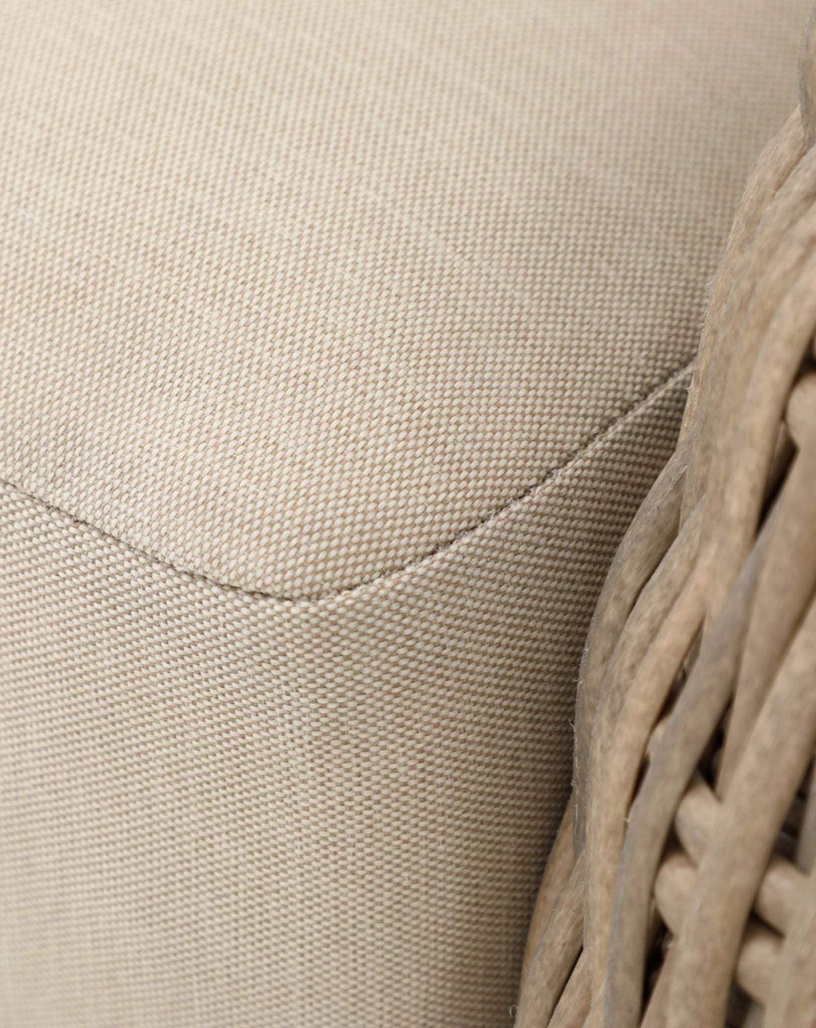 Image of Close-up of a beige woven chair with fabric texture