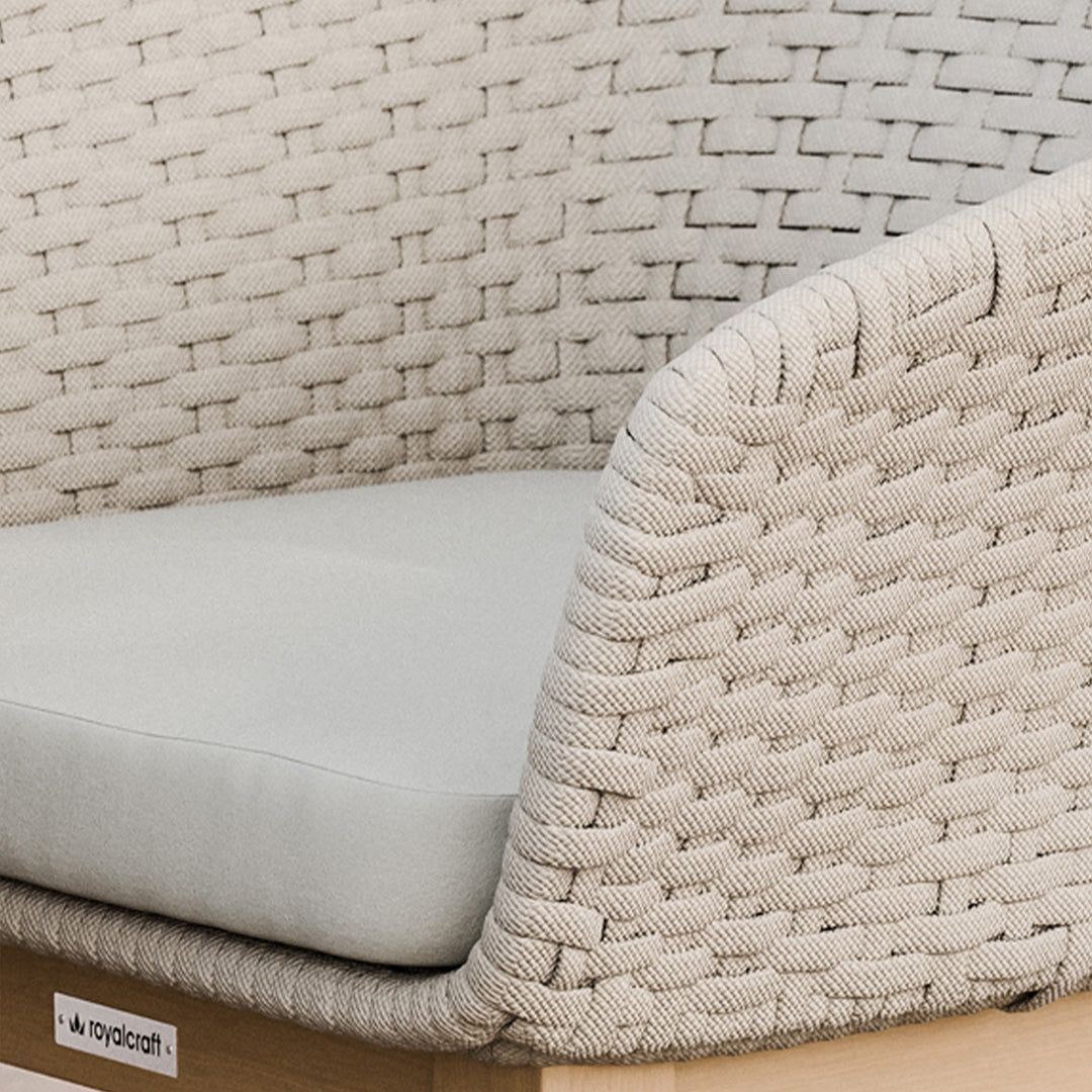 Image of Close-up of a woven chair with a textured backrest and cushion, featuring the Royalcraft brand.