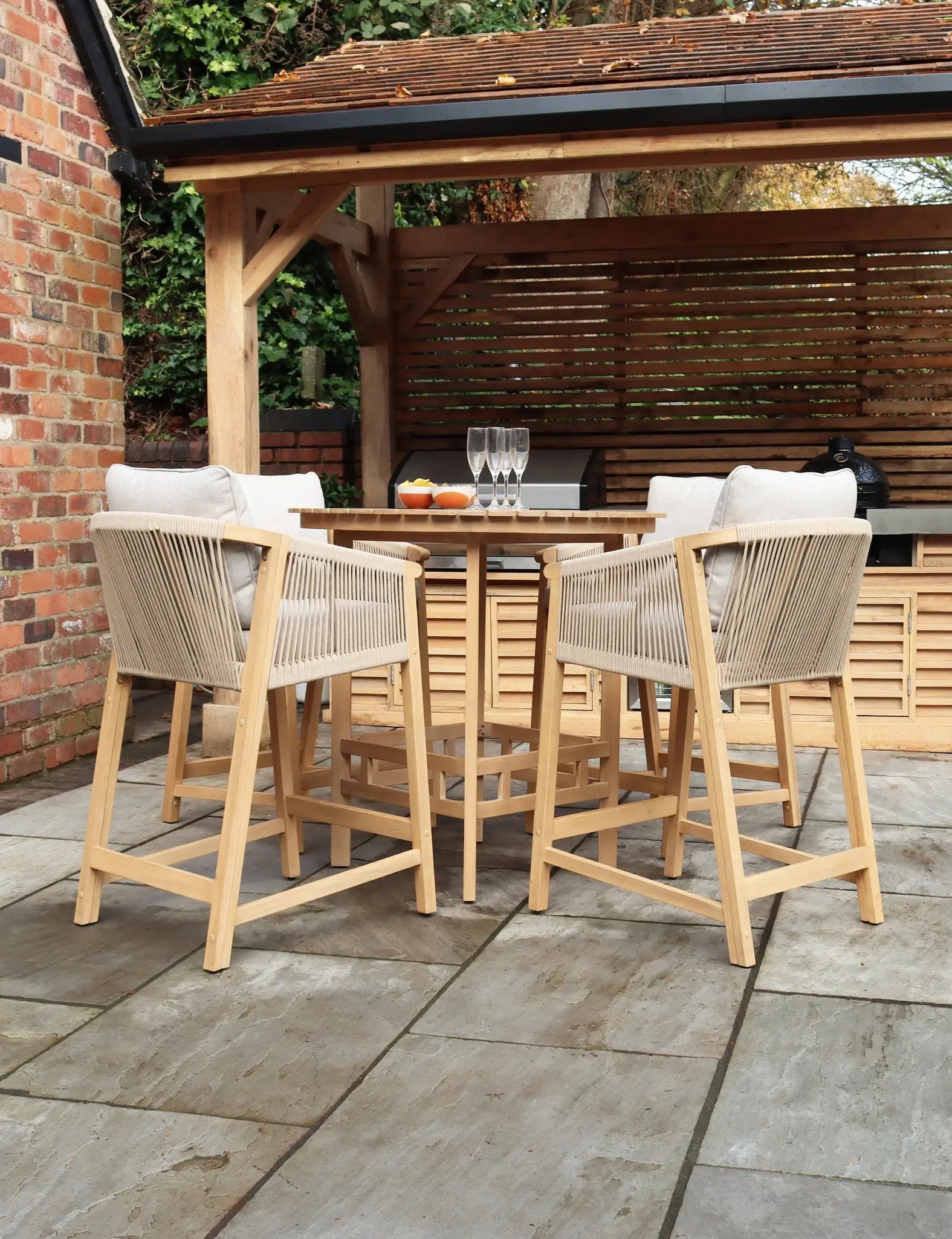 Image of Wooden outdoor bar table with six tall stools