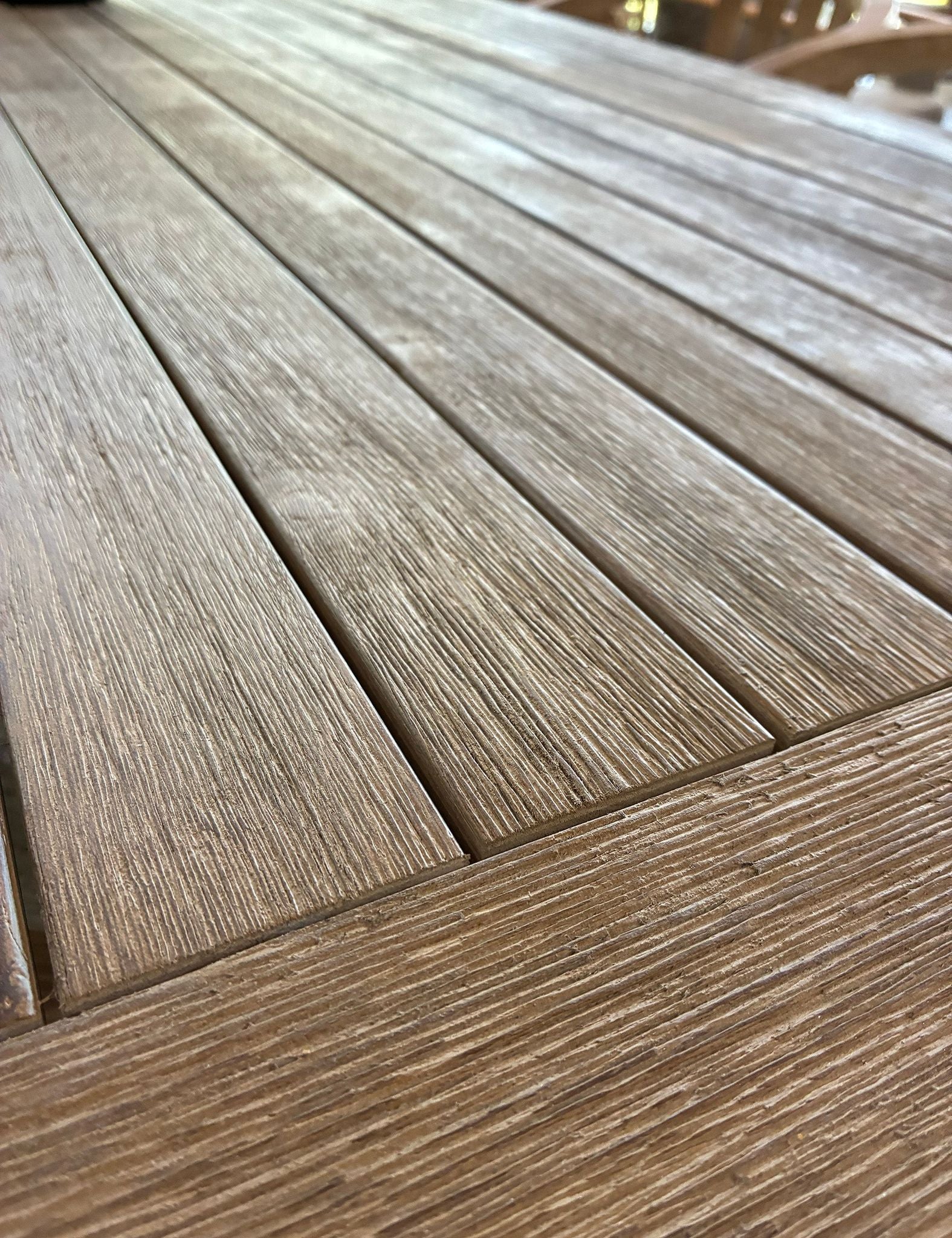 Close-up of wooden deck tiles with a natural wood grain pattern.