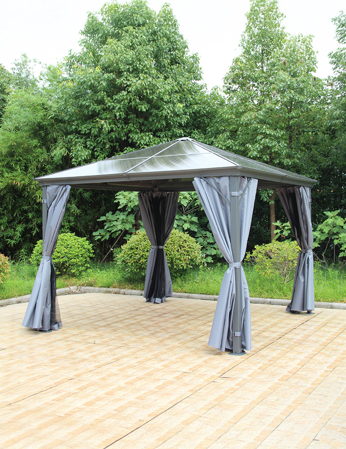 Outdoor gazebo in grey over seating area on stone patio