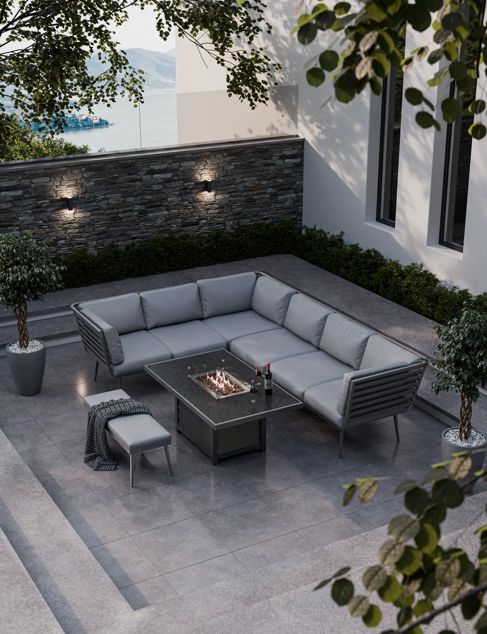 modern grey outdoor fire‚Äö√Ñ√´pit lounge setup with sectional sofa and bench