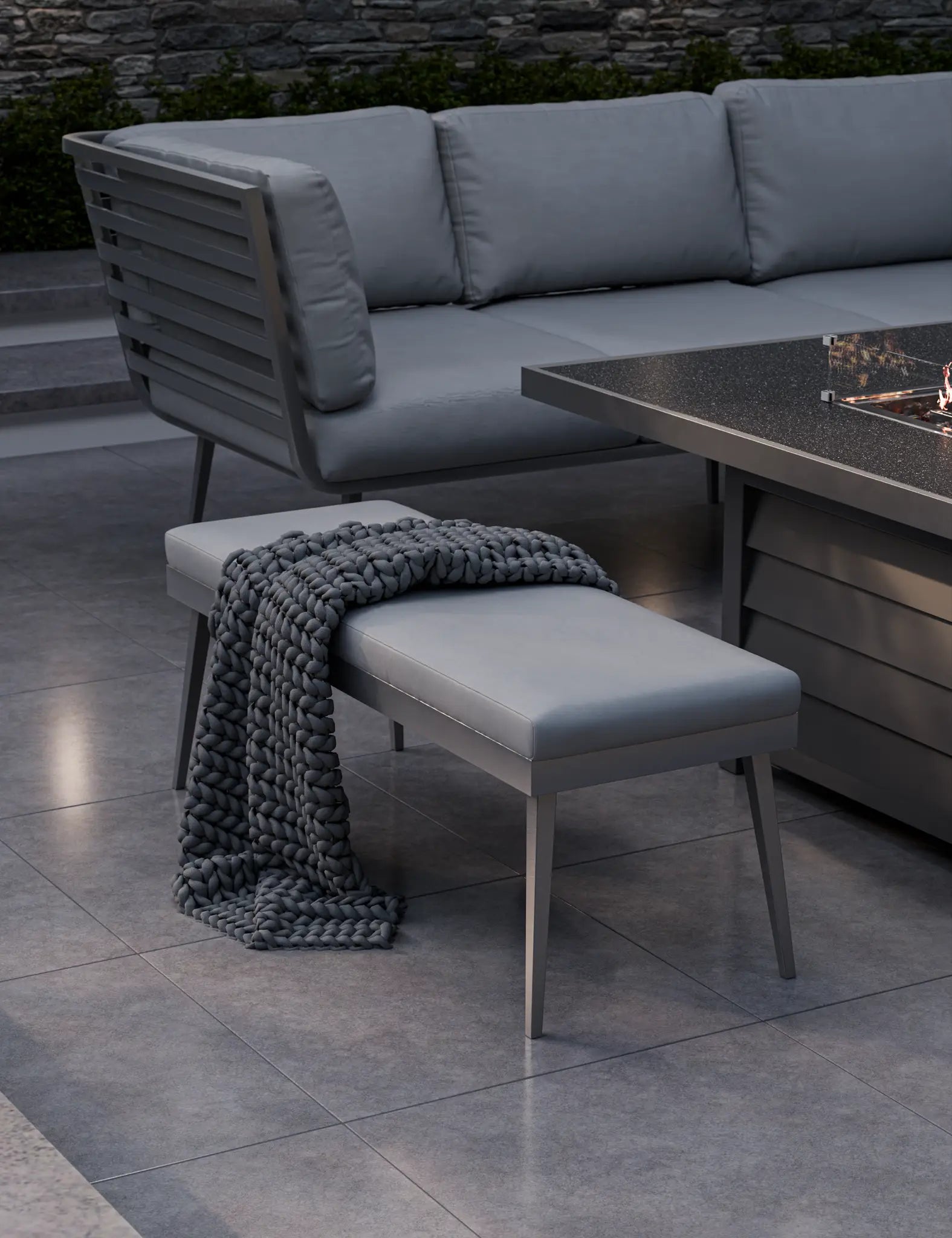 Image of Close‑up of fire table and seating area with grey cushions