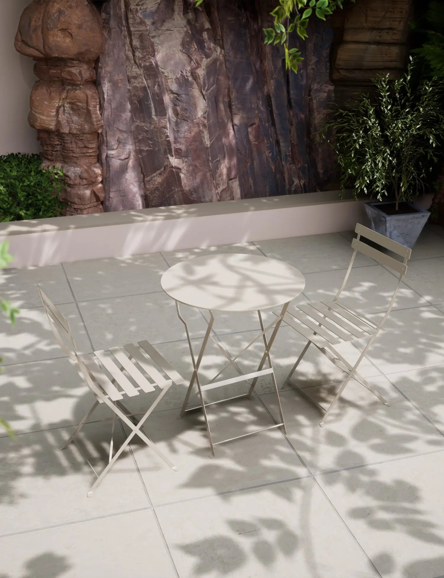 Champagne-colored metal bistro set with round table and two folding chairs