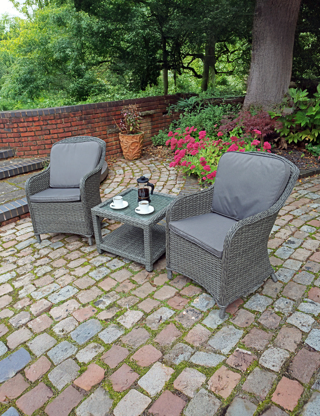 Grey rattan companion set with two cushioned chairs and side table