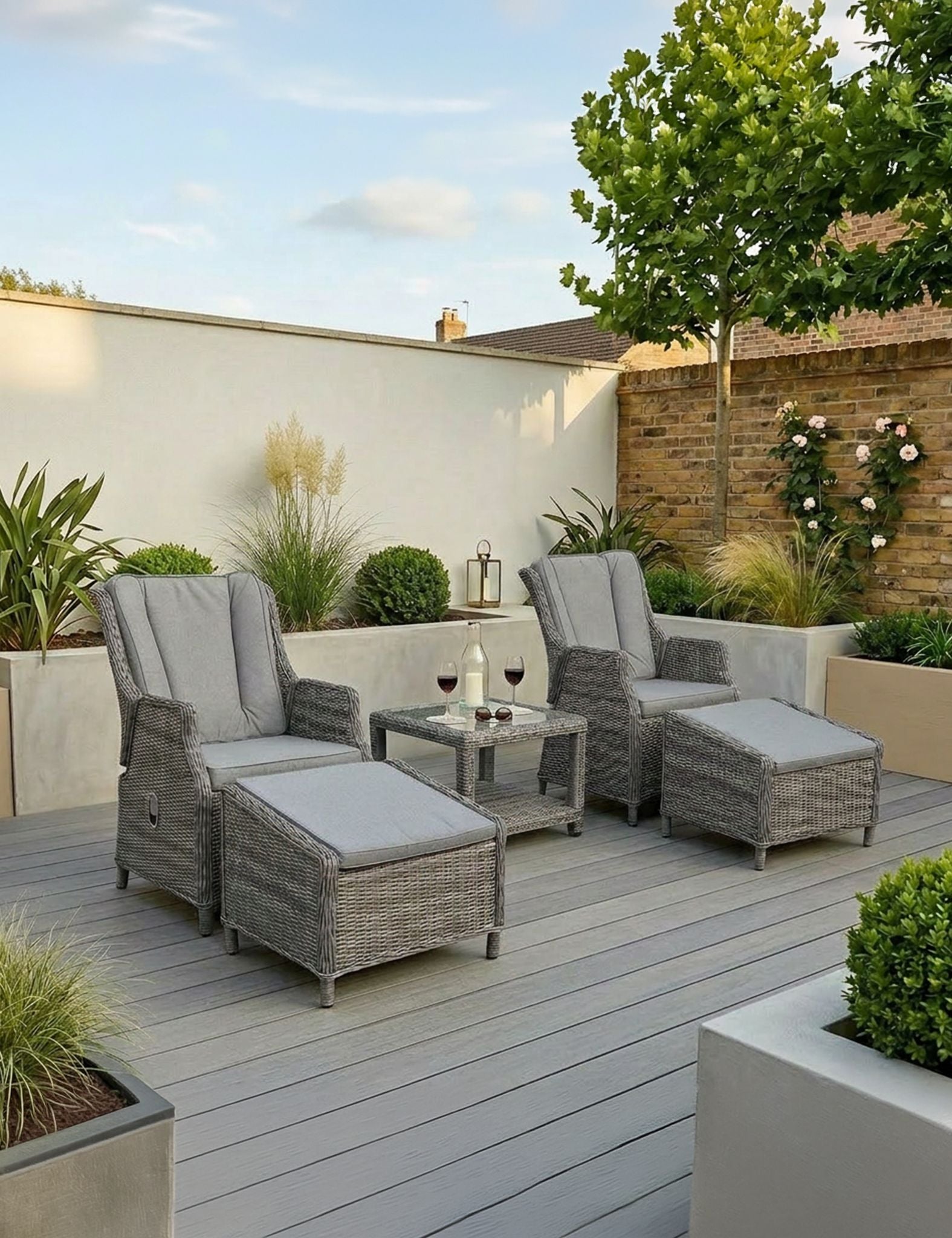 Image of Outdoor patio setup with wicker furniture, table, and plants on a wooden deck.