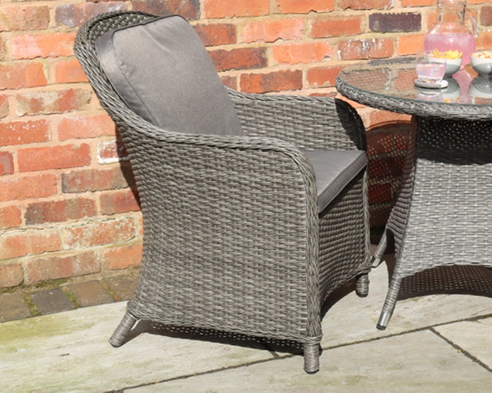 Grey rattan outdoor armchair with seat and back cushion