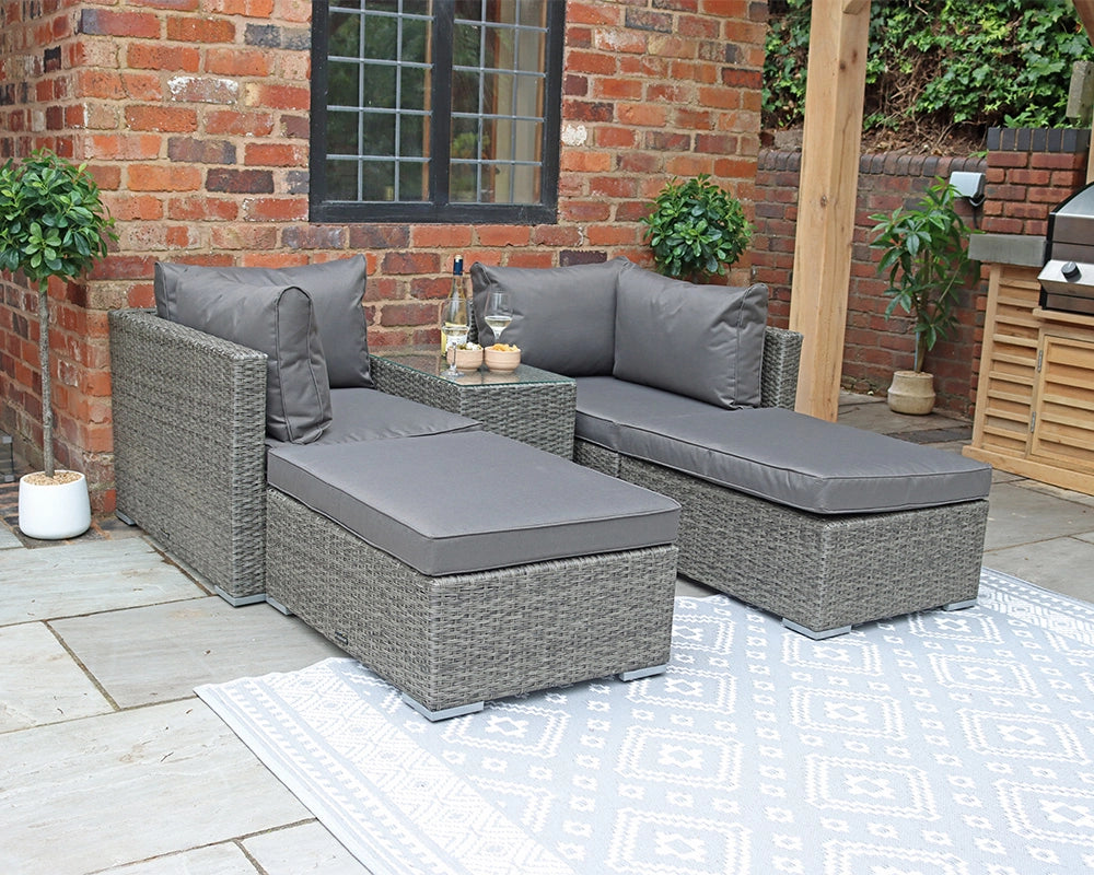 Grey outdoor rattan corner sofa set with cushions on patio