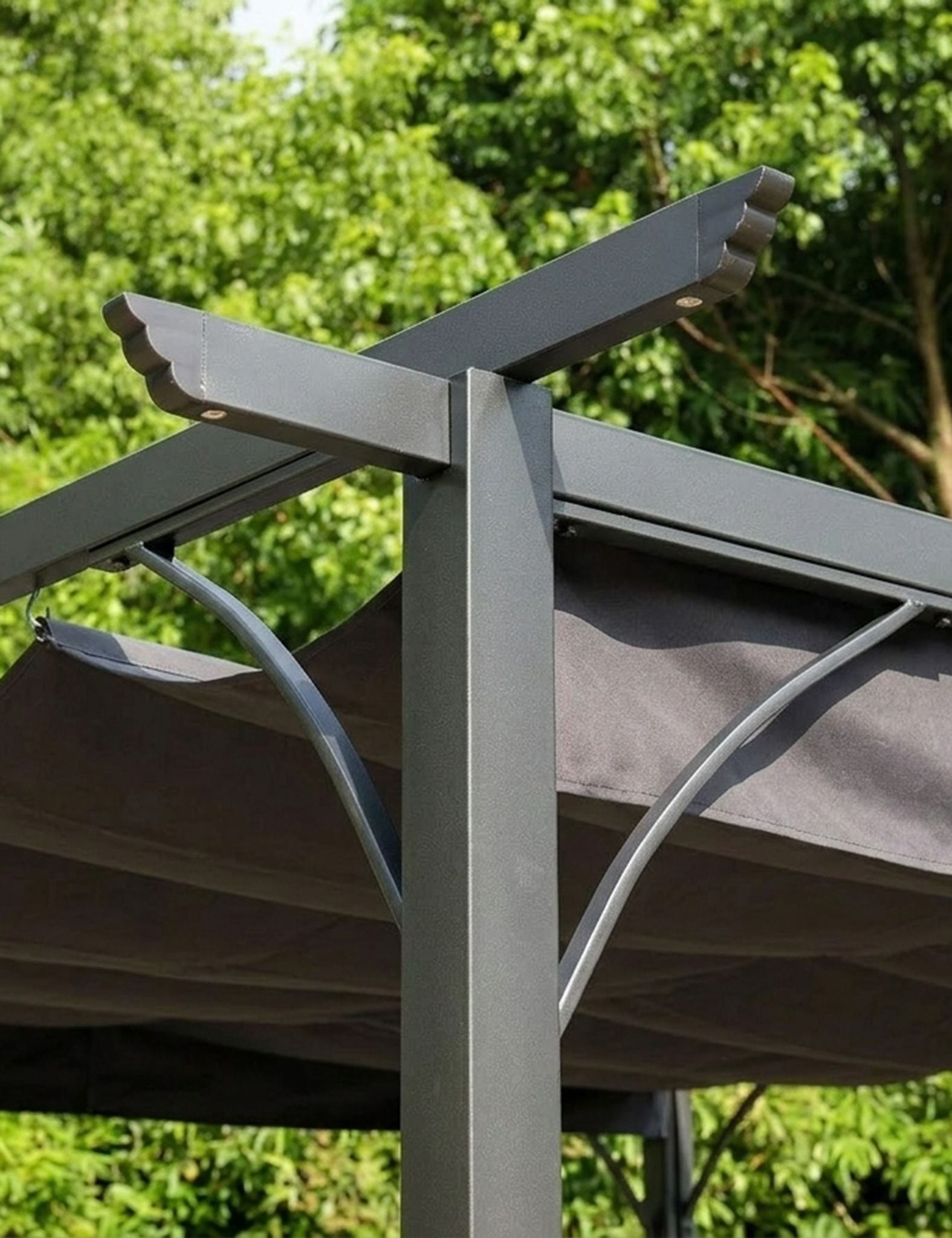 Image of Pergola structure with a fabric cover against a green tree background