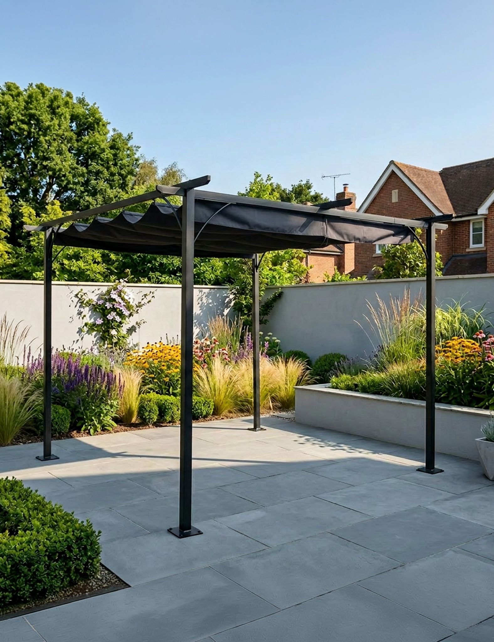 Image of Black pergola structure on a patio with garden and house in the background