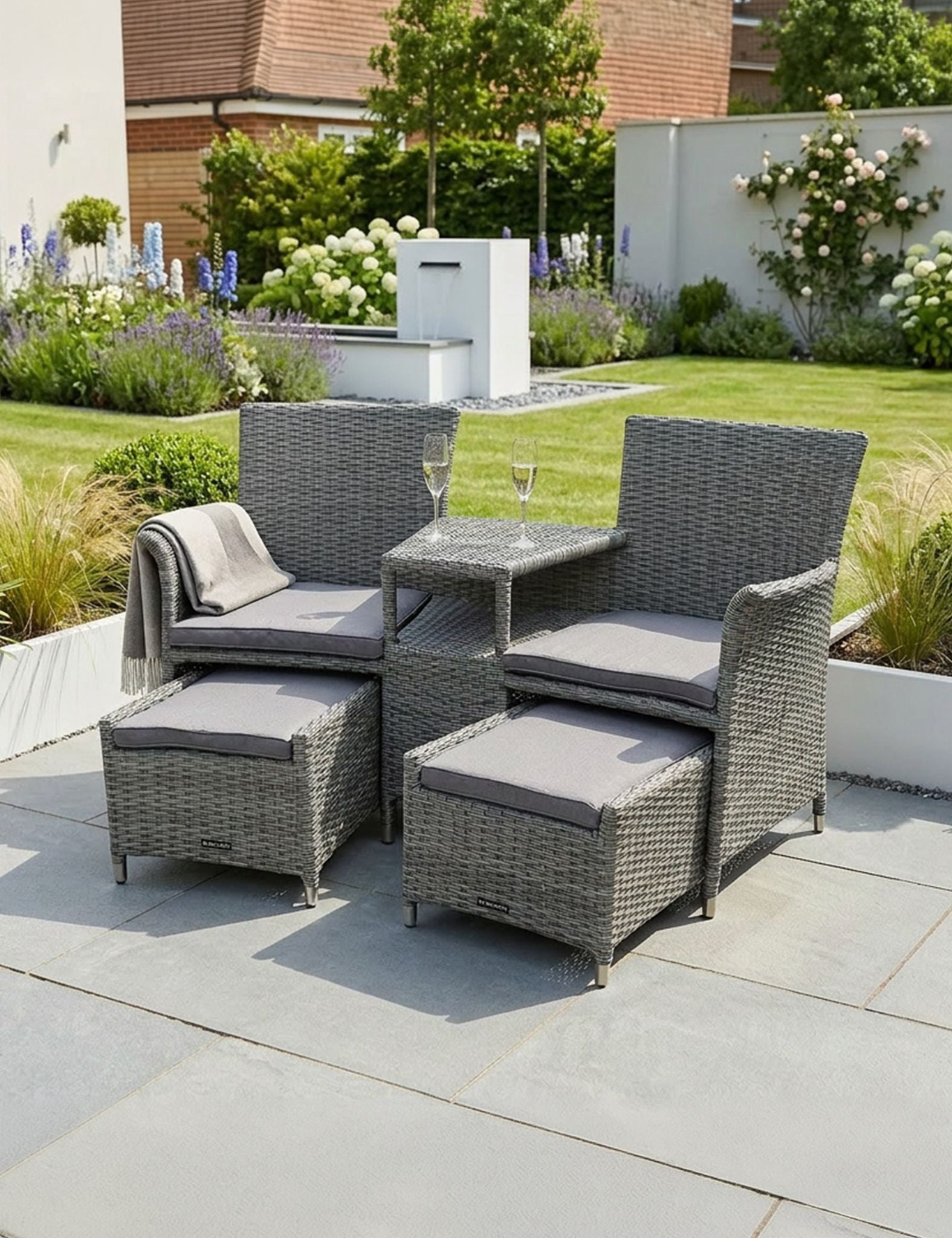 Image of Outdoor patio furniture set with chairs, table, and ottomans on a patio.