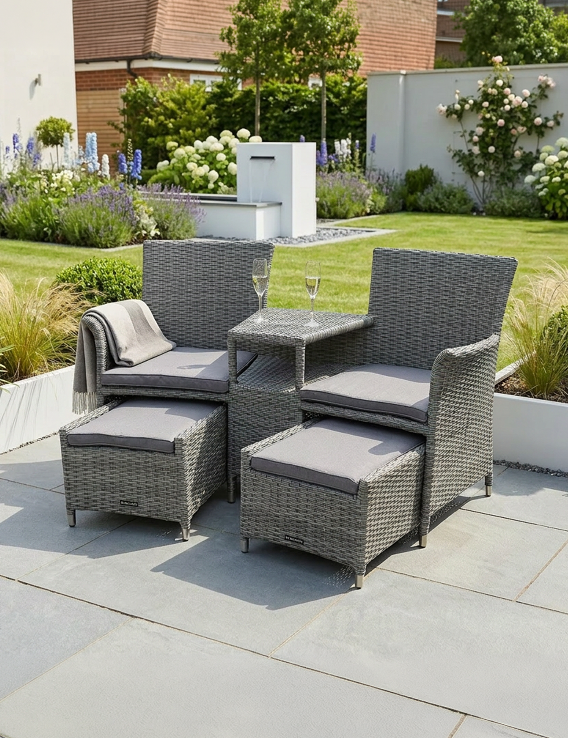 Image of Outdoor patio furniture set with chairs, table, and ottomans on a patio.