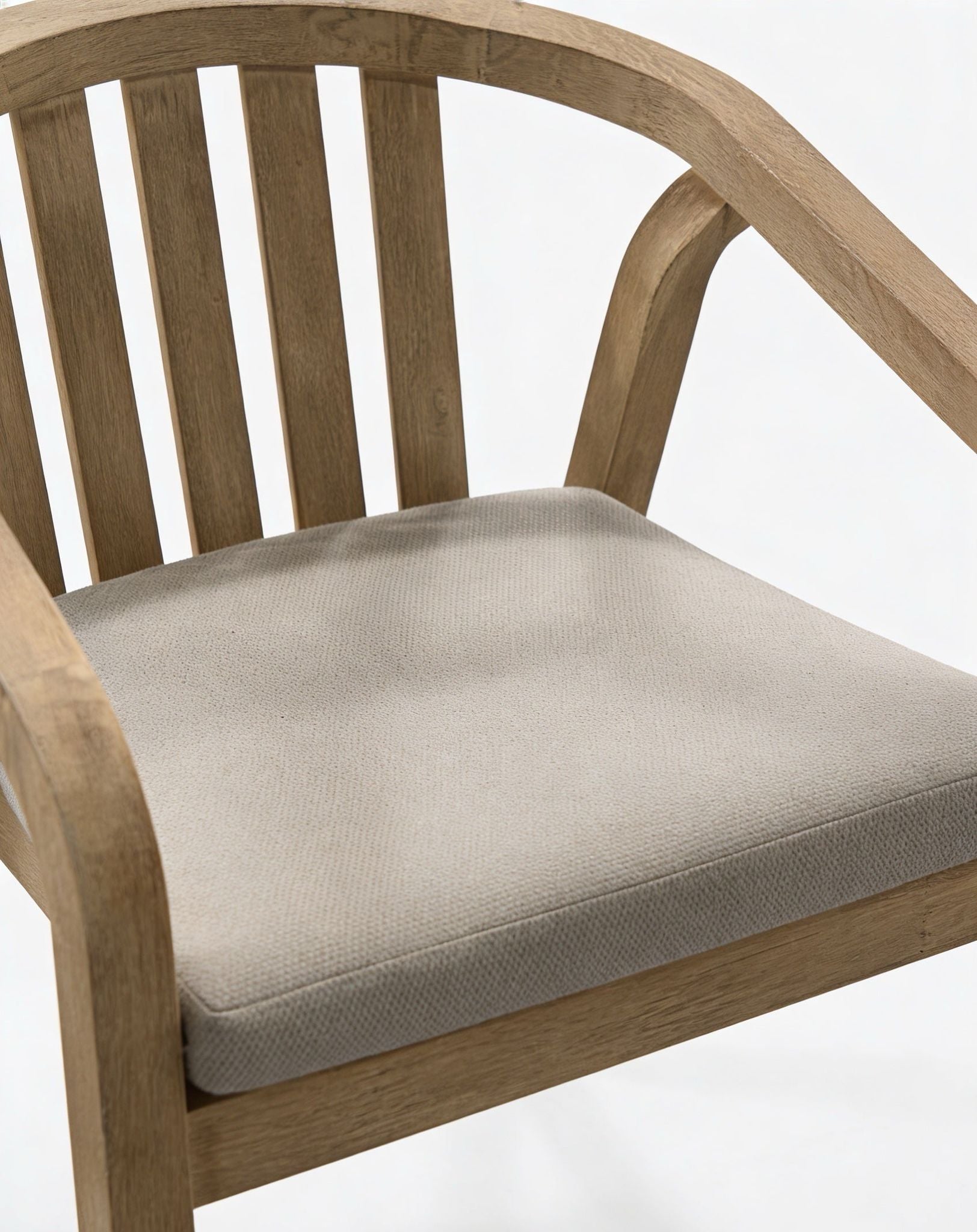 Wooden chair with a beige cushion on a white background