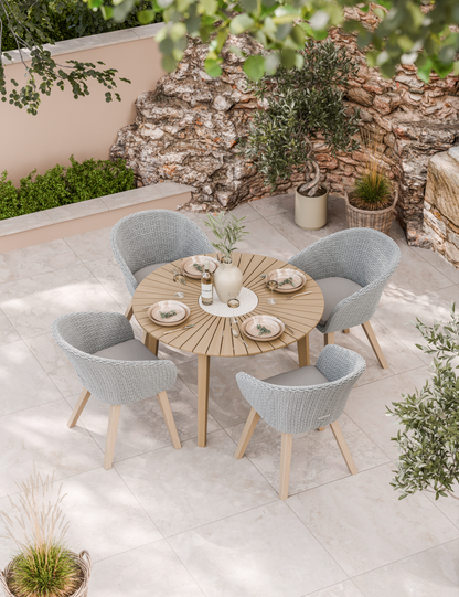 Outdoor dining set with round wooden table and four grey chairs