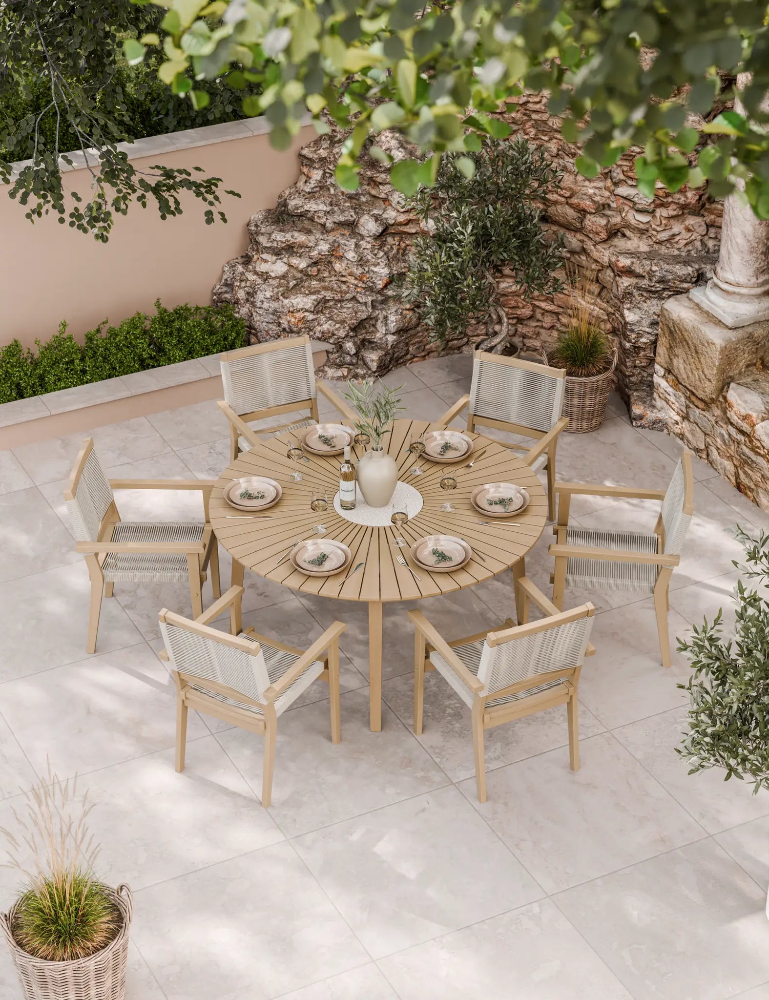 Round outdoor dining table with six cushioned rope chairs