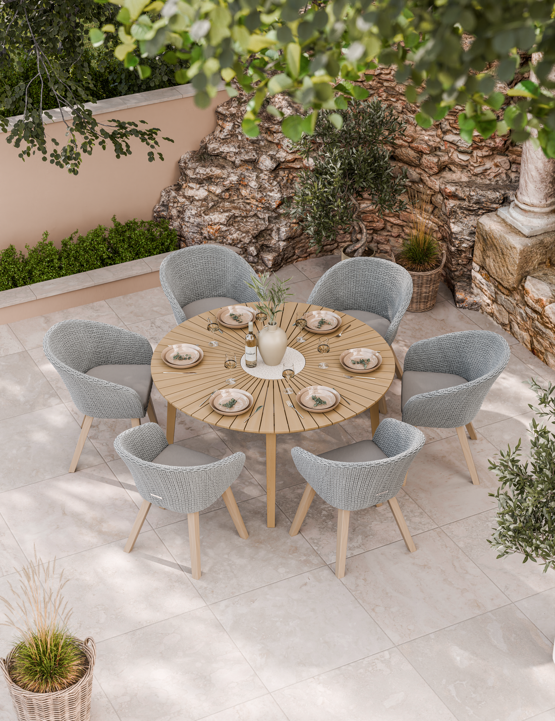 Round patio dining set with six chairs under a leafy tree