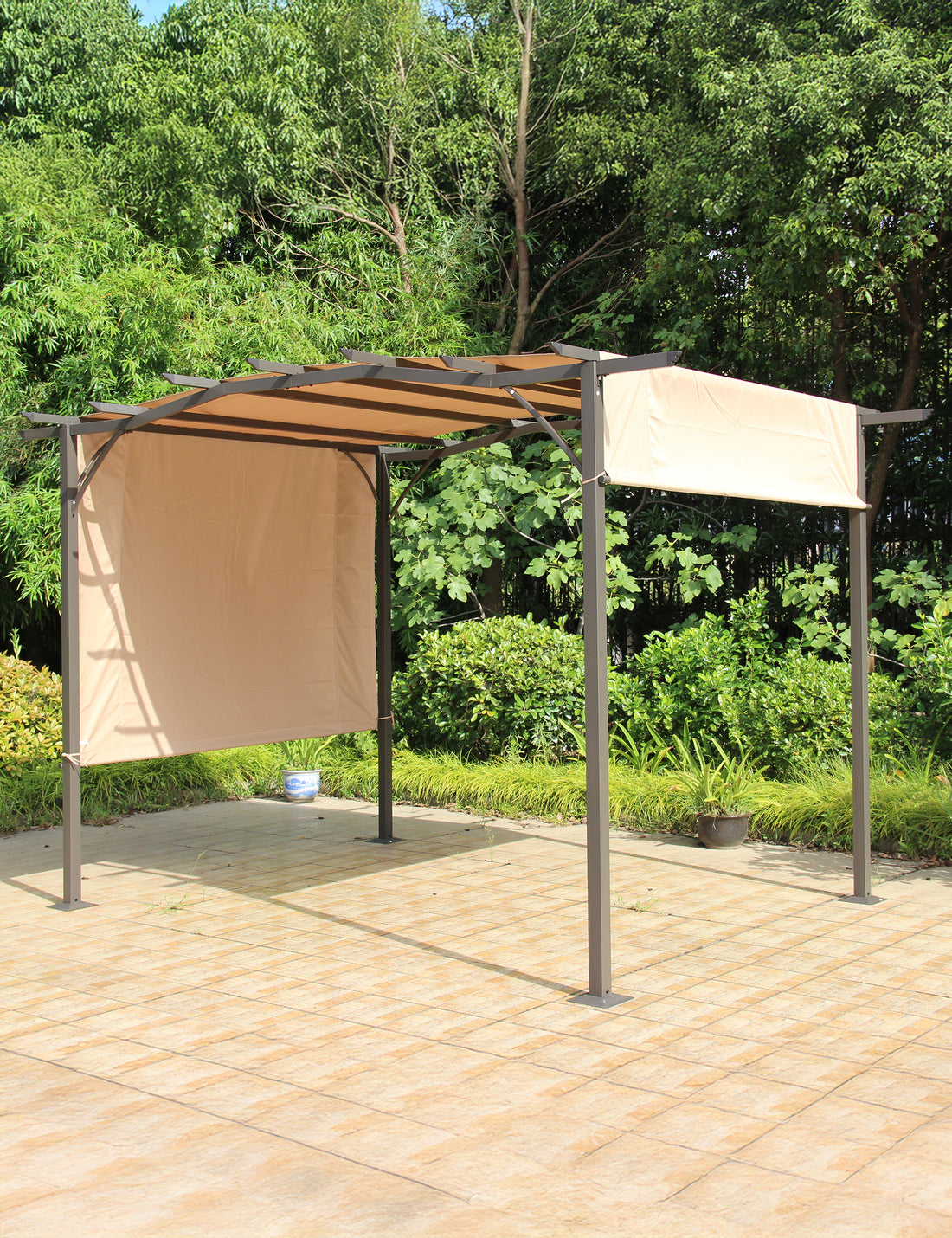 Beige pergola with retractable canopy in garden setting