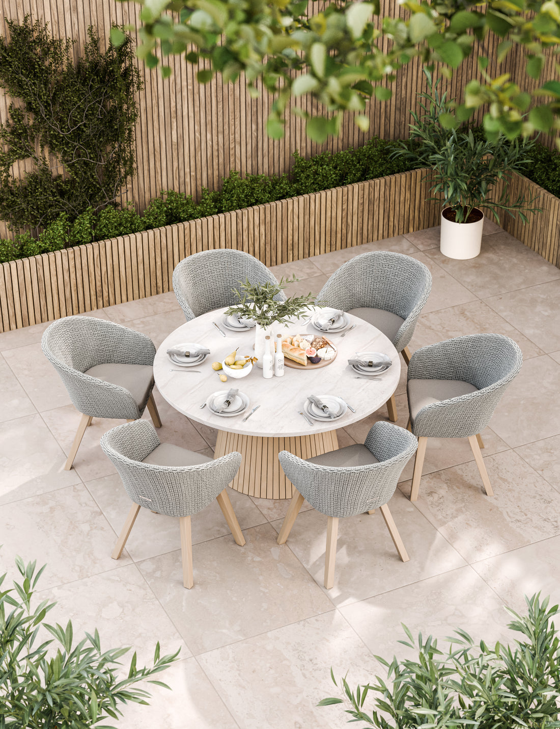 Grey outdoor dining set with round table and six chairs