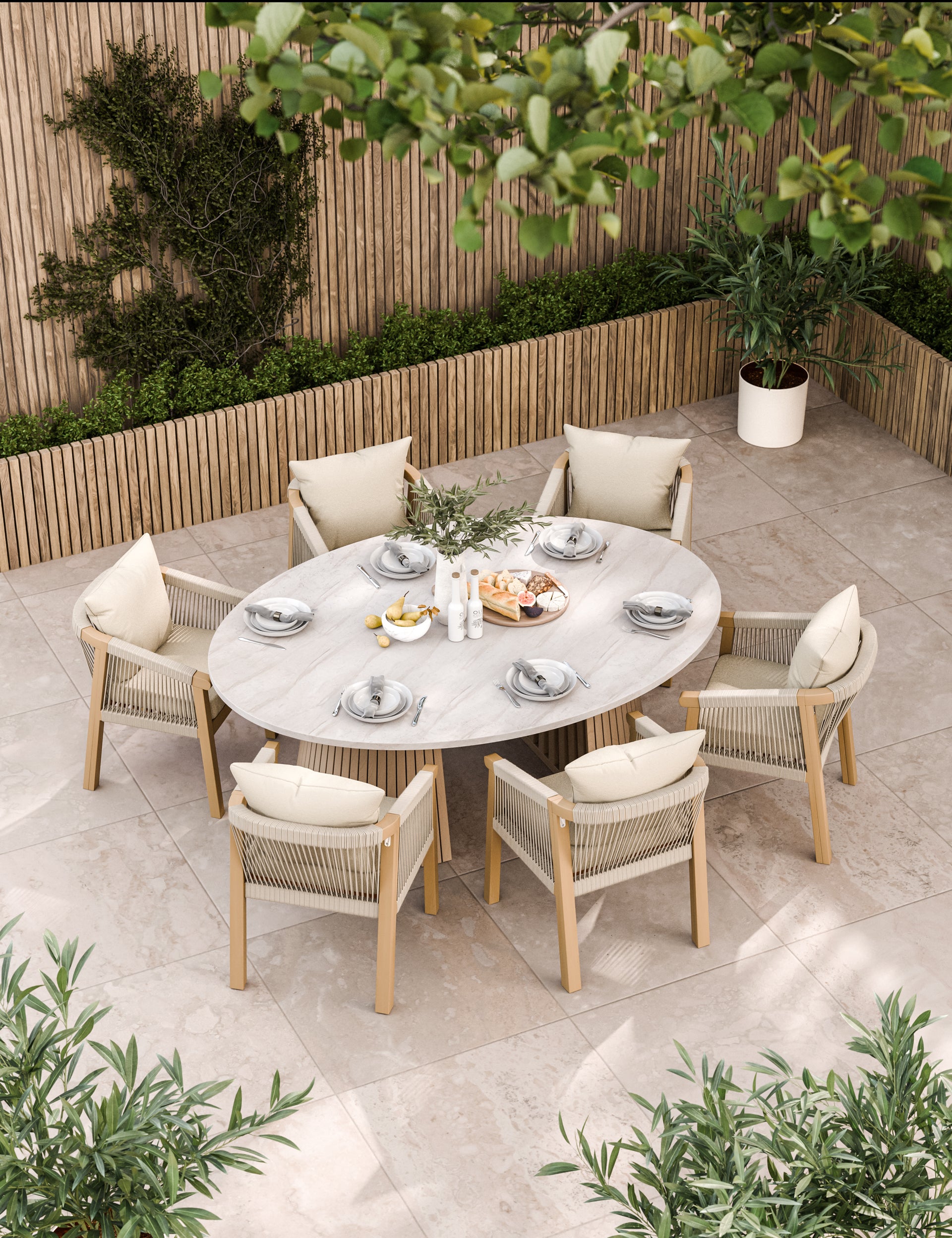 Oval outdoor dining table with six cream cushioned chairs