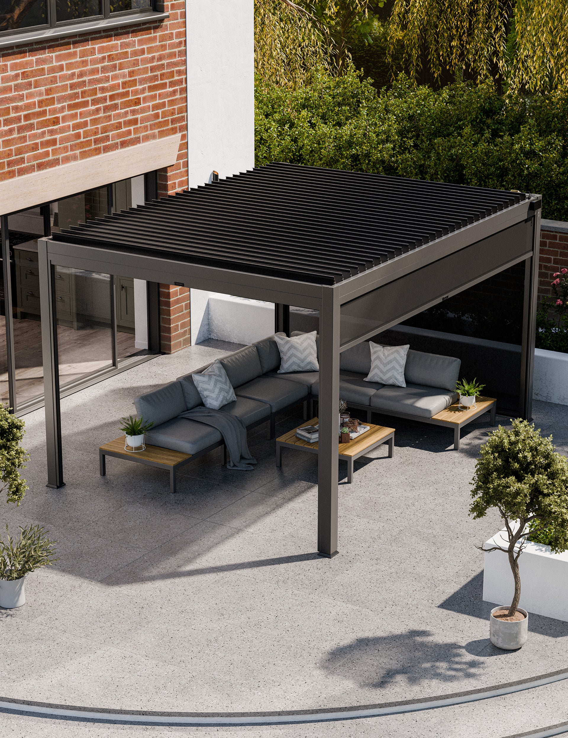 Image of Modern black pergola with grey outdoor sofas on a stone patio
