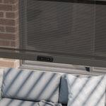 Outdoor pergola with a sofa underneath showcasing a privacy screen