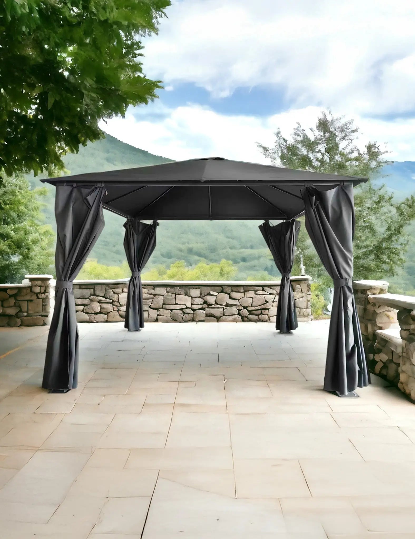 Image of Black outdoor gazebo with curtains on a stone patio overlooking hills