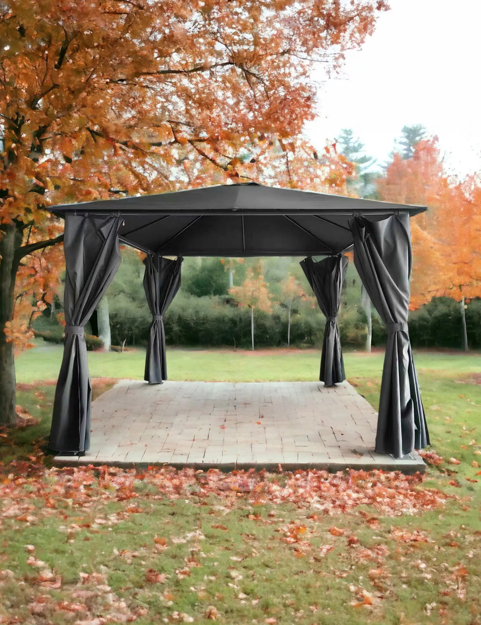 Black outdoor gazebo with curtains set on grass among autumn trees