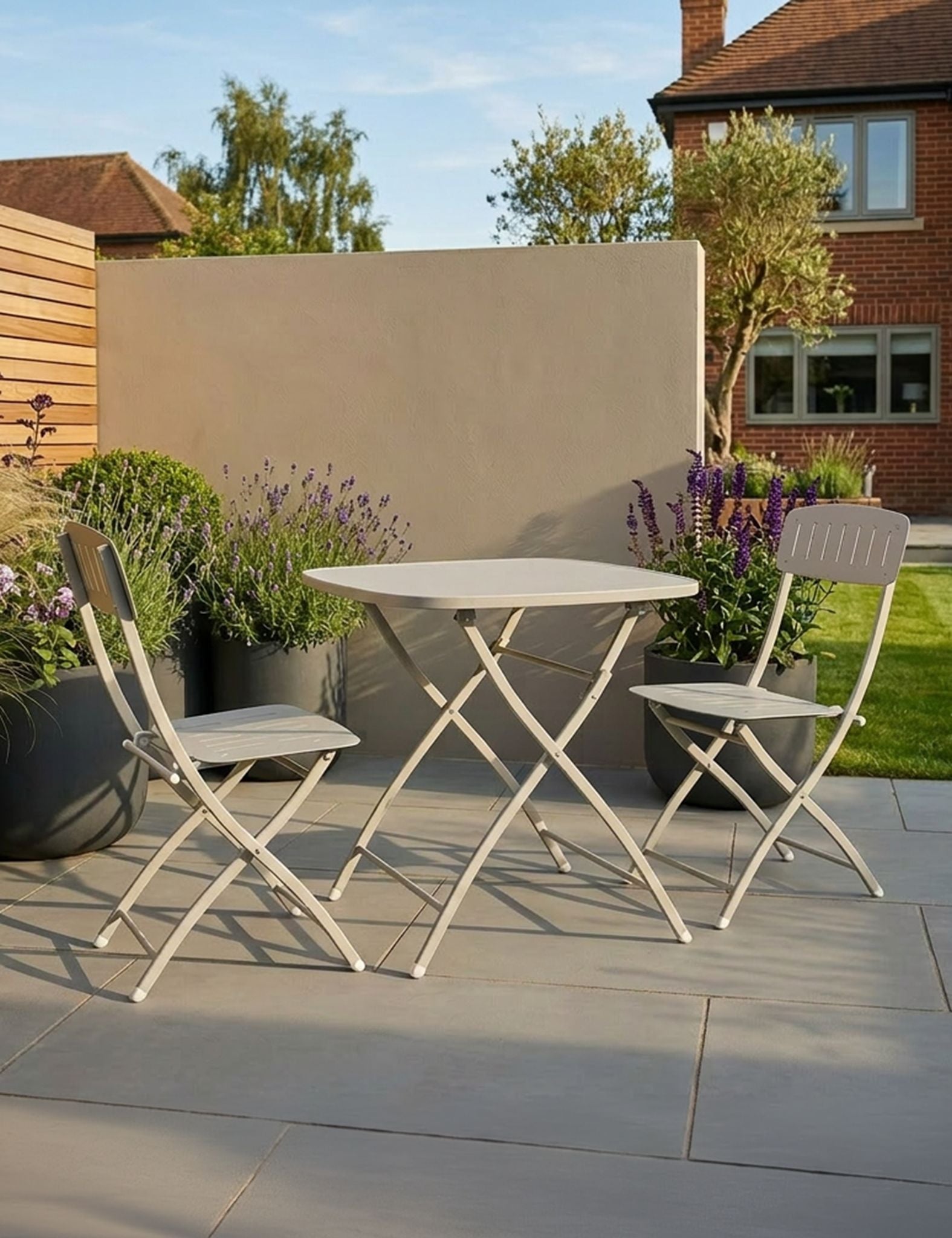 Image of Outdoor patio set with table and chairs on a paved patio area.
