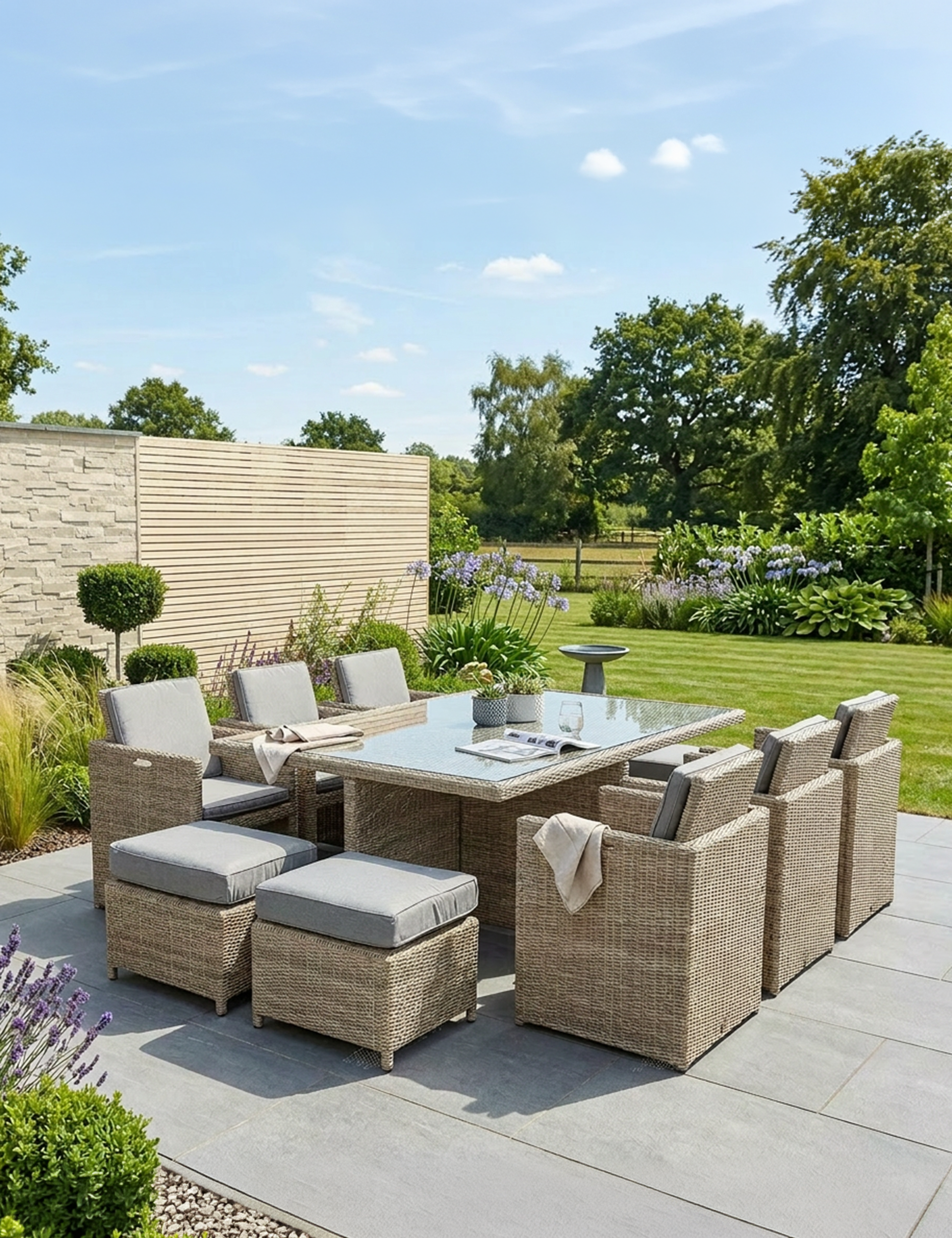 Image of Outdoor patio set with table and chairs on a paved area with a garden background