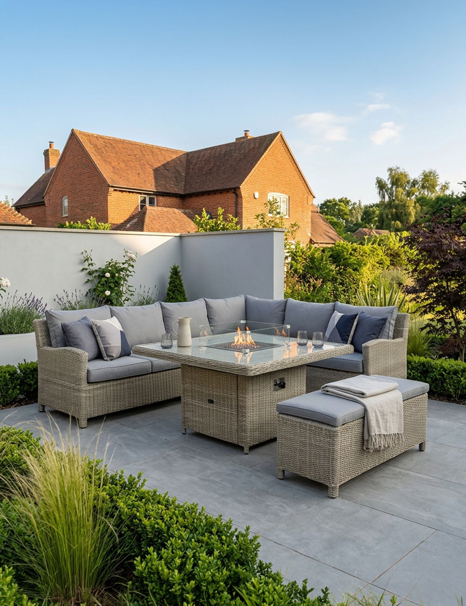 Image of Outdoor patio set with fire pit table in a garden setting.