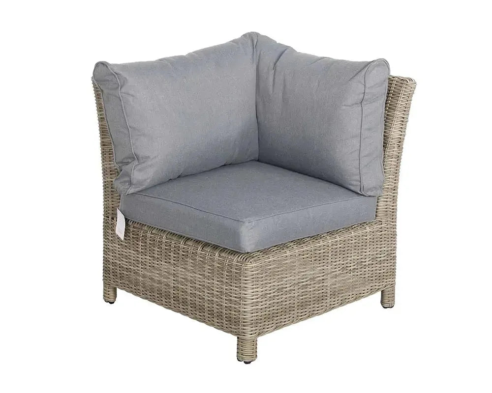 Image of Corner chair with wicker frame and gray cushions on a white background