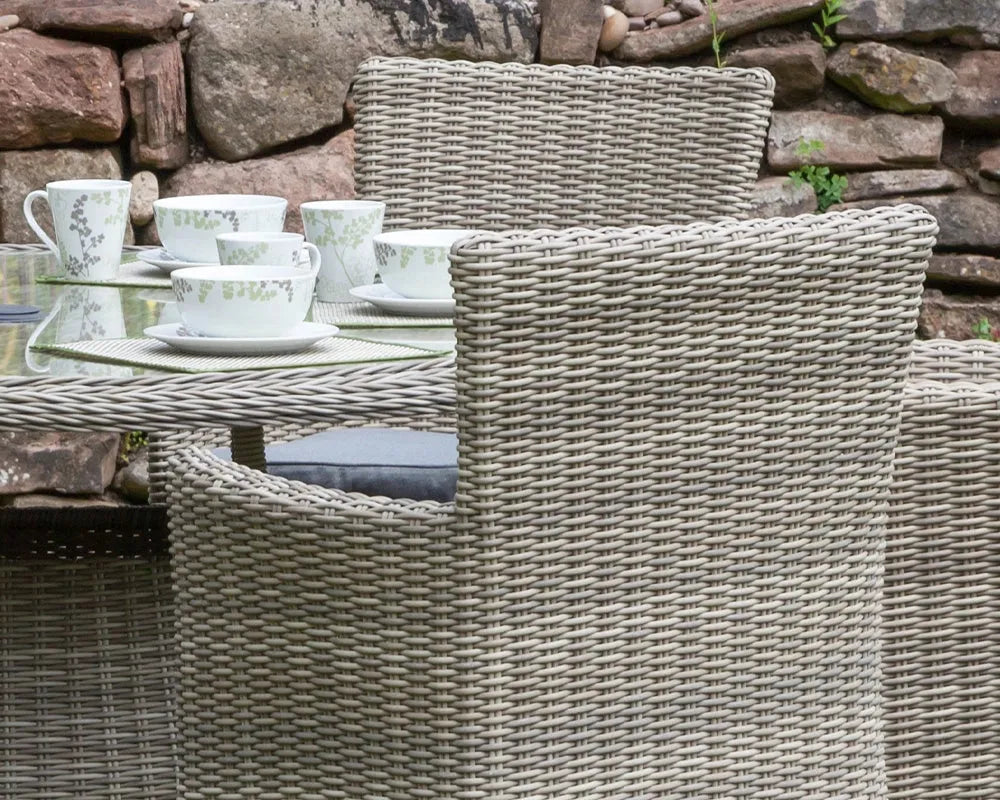 Image of Rattan outdoor furniture set with a stone wall background