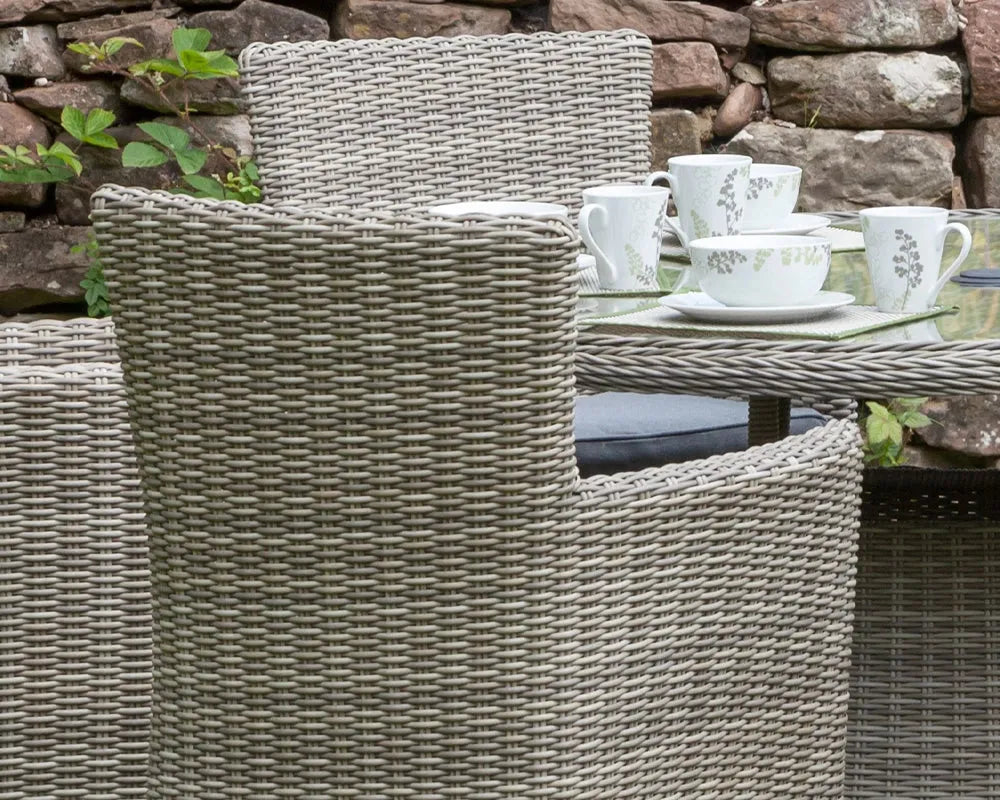 Image of Rattan chairs with a table set for tea in an outdoor setting.